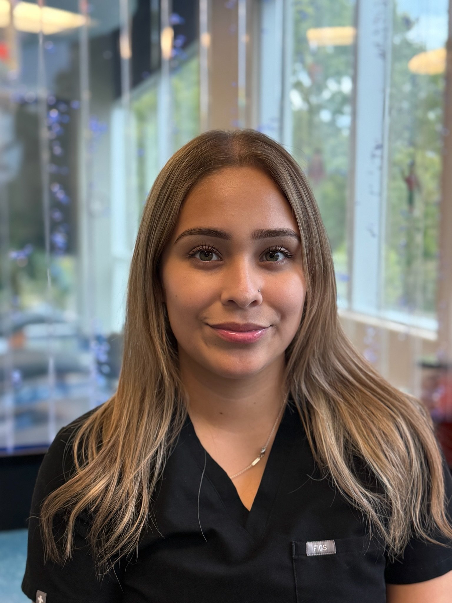 Staff member, Beatriz smiling in the pediatric dental office