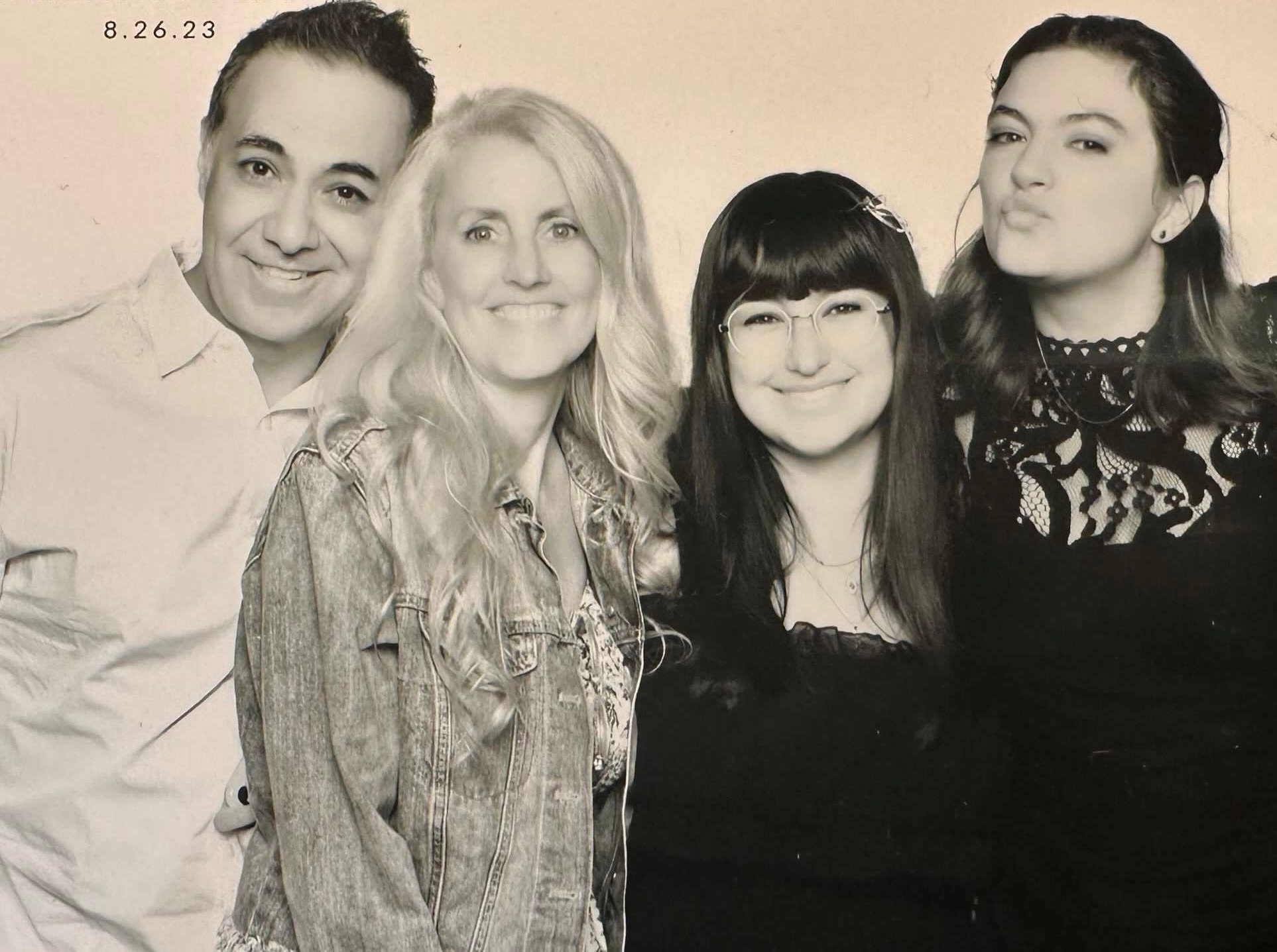 Black-and-white family portrait of Dr. Ray with his wife and two daughters