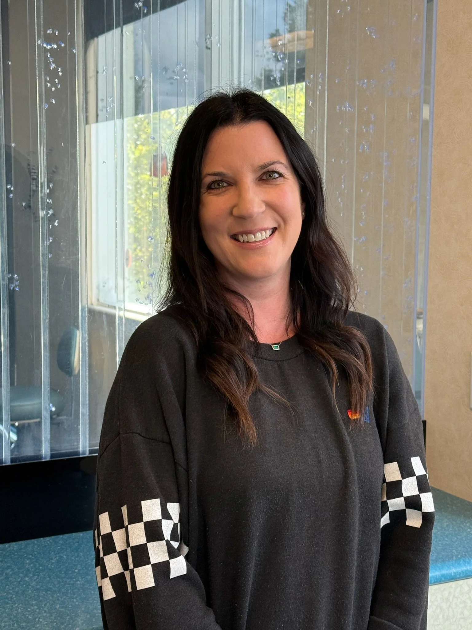 Staff member, Stacy smiling in the pediatric dental office