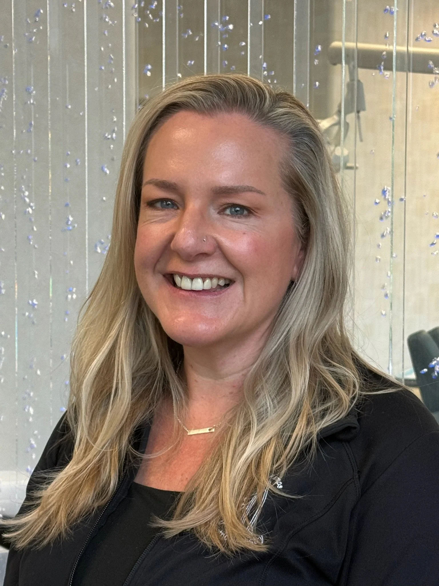 Staff member, Jenn smiling in the pediatric dental office