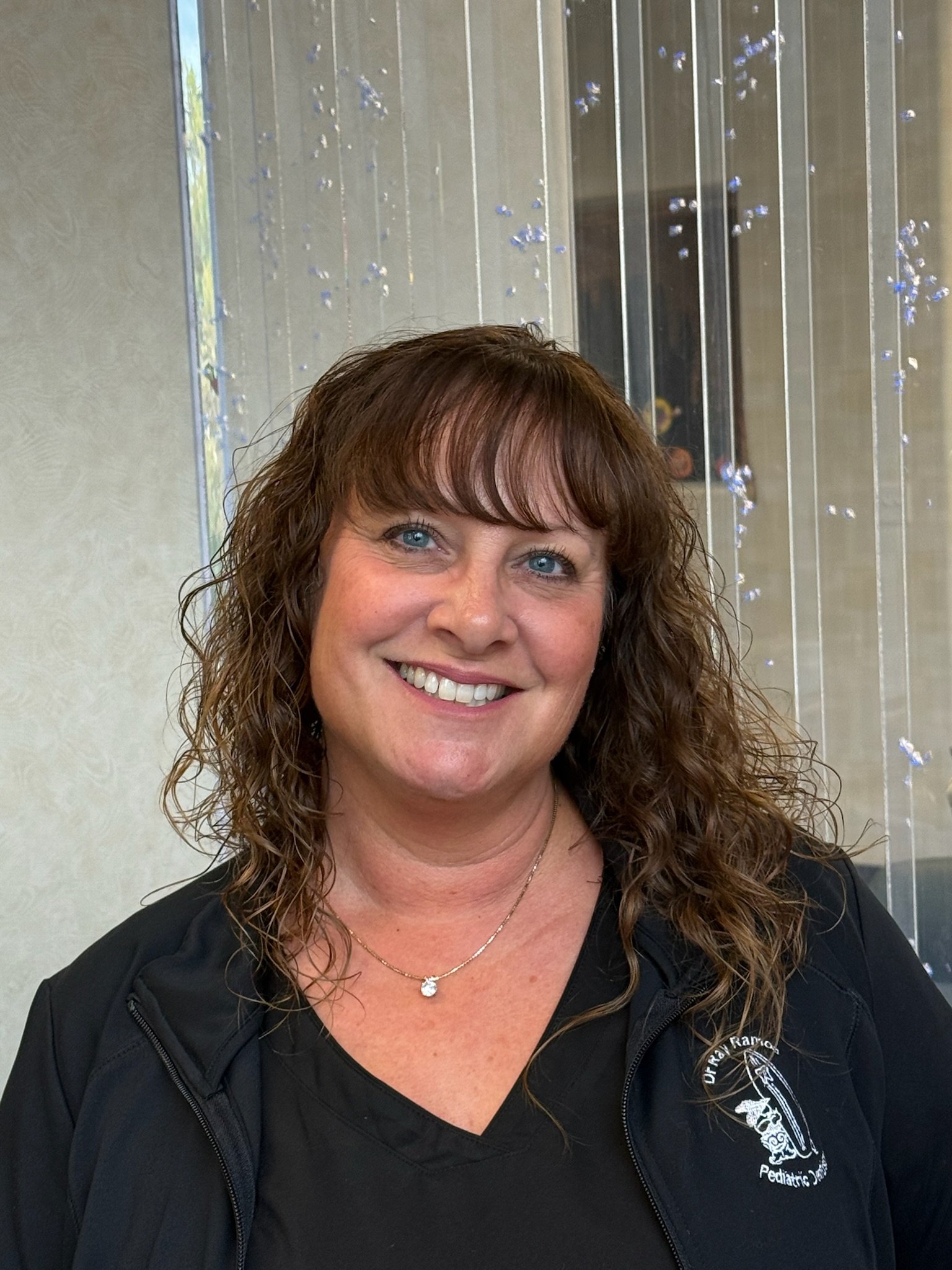 Staff member smiling in the pediatric dental office