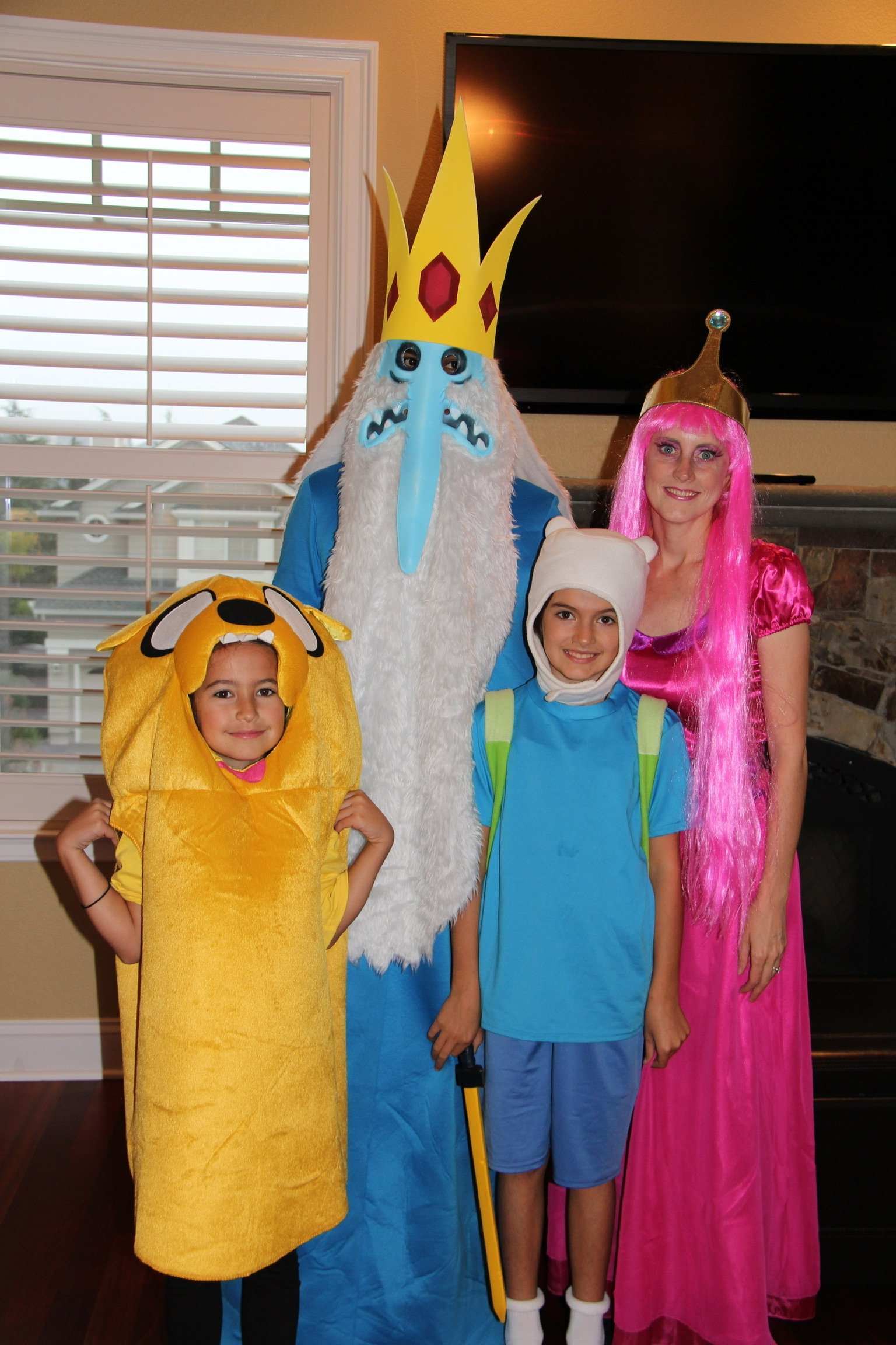 Dr. Ray posing with his wife and two daughters on Halloween dressed in costumes
