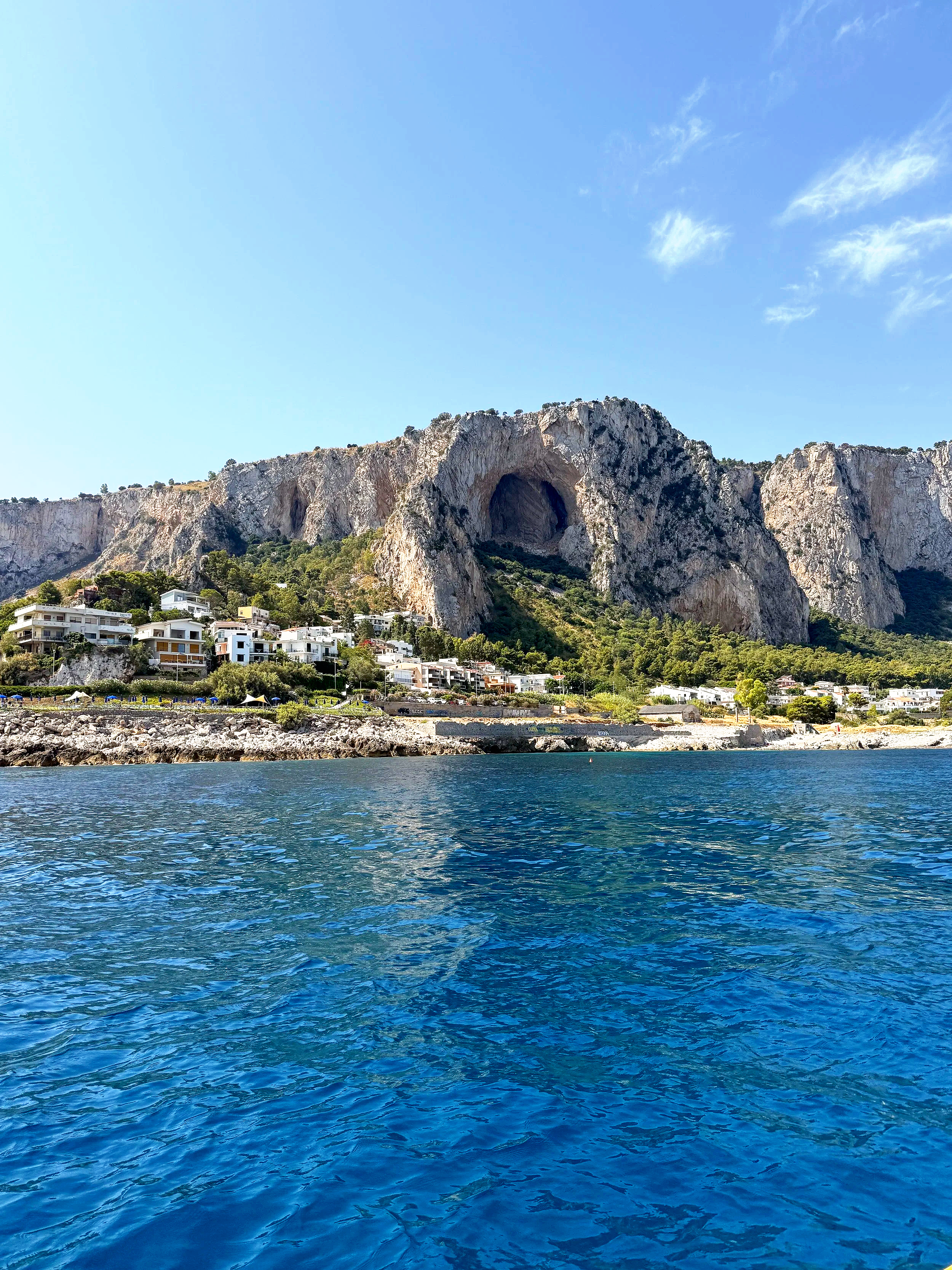 Scenic view of a ocean surrounded by mountains under an overcast sky