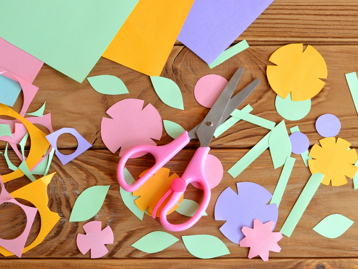 woman puts hand on heart with eyes closed in front of a background of holiday lights.