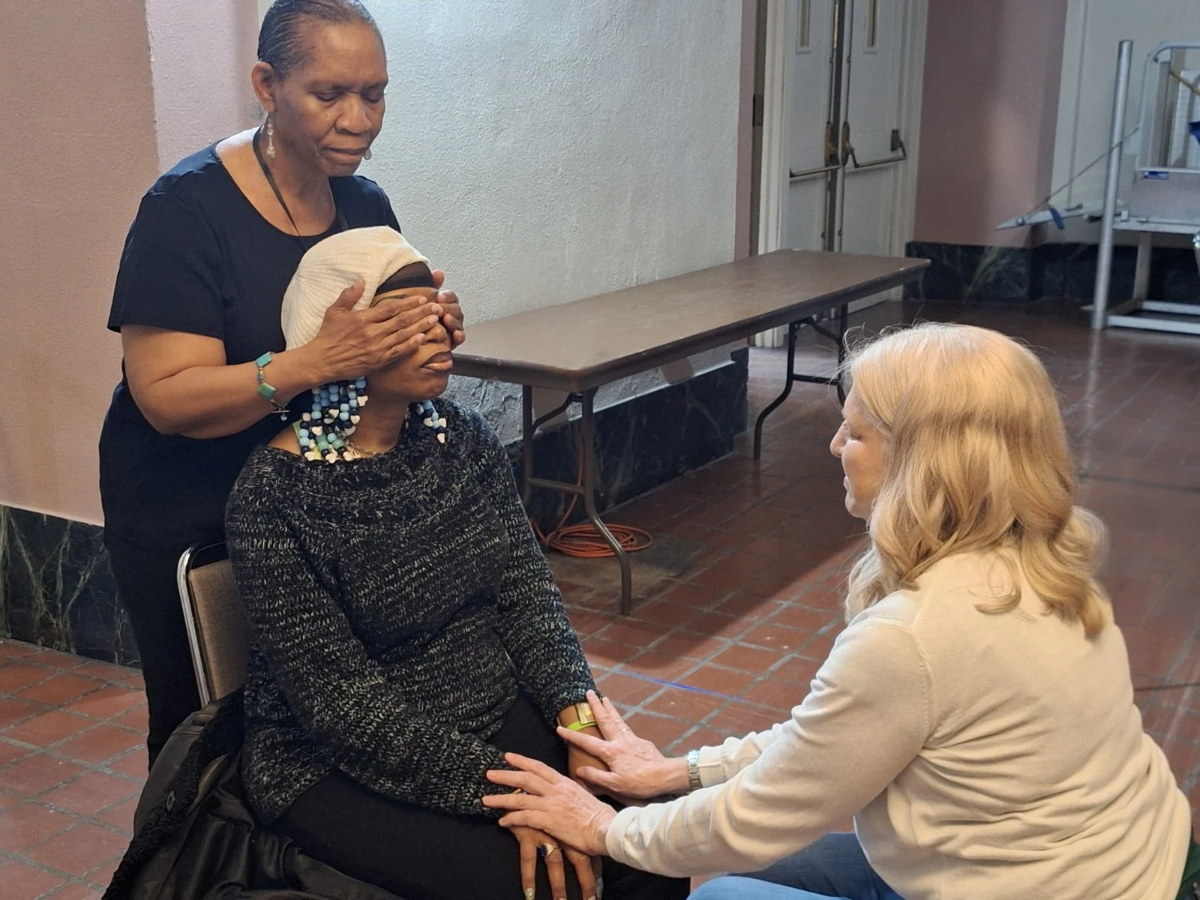A woman relaxes receiving Chair Reiki