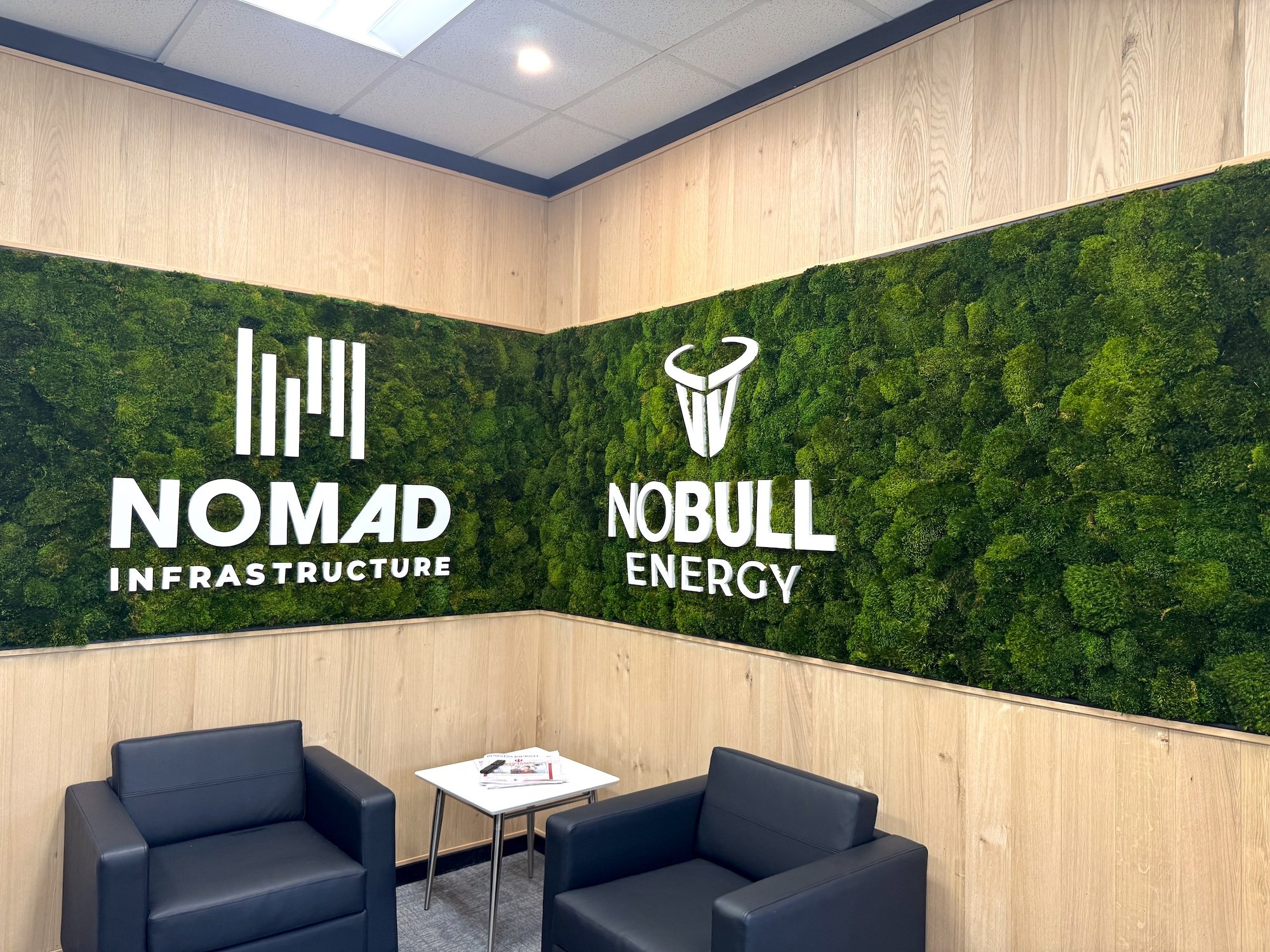 Mood moss wall with white acrylic logo. NOMAD Infrastructure and NOBULL Energy located in Carmel, IN.