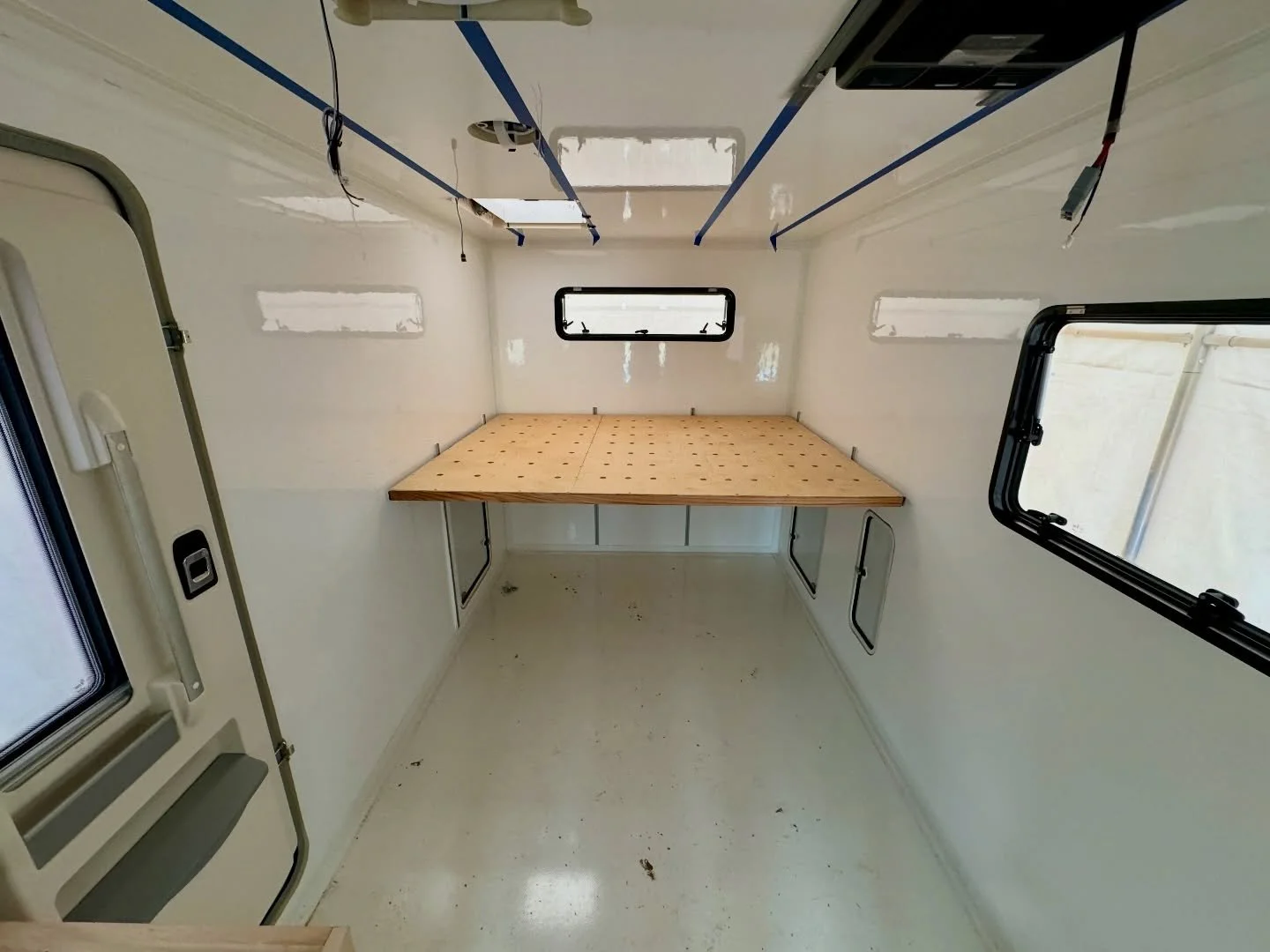 A bed that does more than just sleep.

Our queen bed is elevated to create garage storage underneath.
We bonded 80/20 to the walls and set the frame on angle aluminum, giving us vertical adjustability so the space can change as our needs do. 🔧
The p