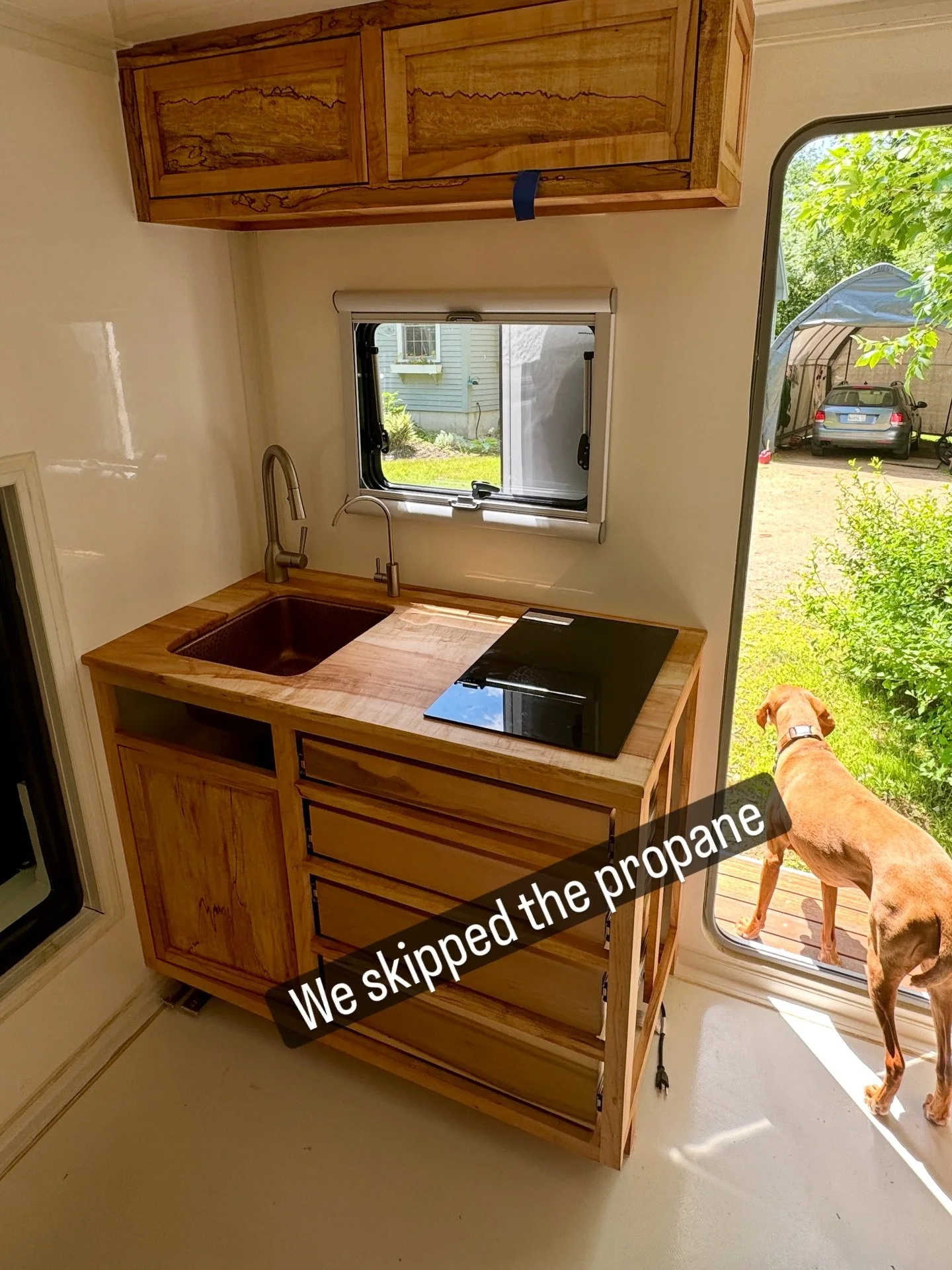 We skipped propane.

This kitchen runs on a 2-burner induction cooktop&mdash;and it fits this build a lot better than propane. ⚡️
Faster heat, higher efficiency, and no open flame inside a small space. It keeps heat where you want it (in the pan), wi