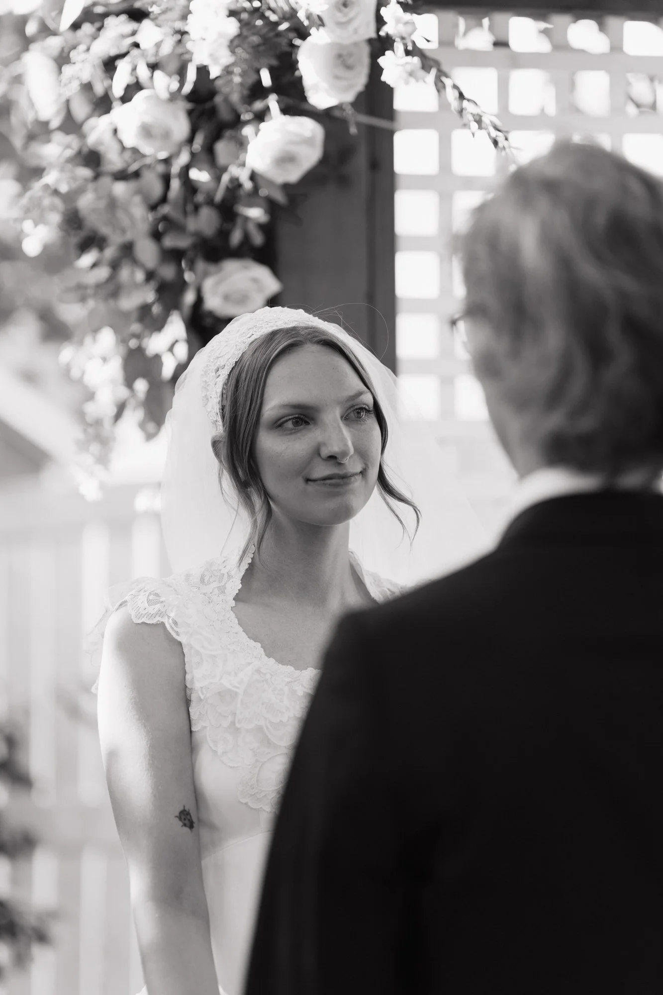 Black and white photo of Zoe looking at Hunter during their vows.