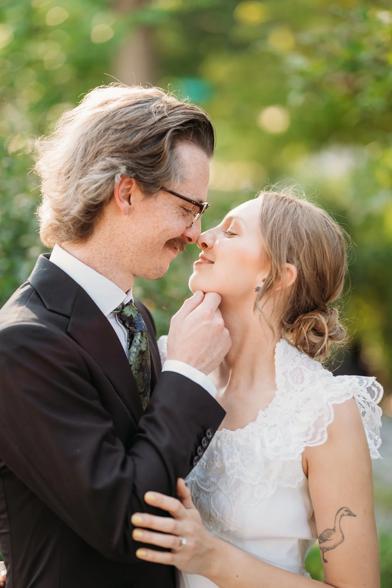 Hunter holds Zoe's chin as they lean in close.