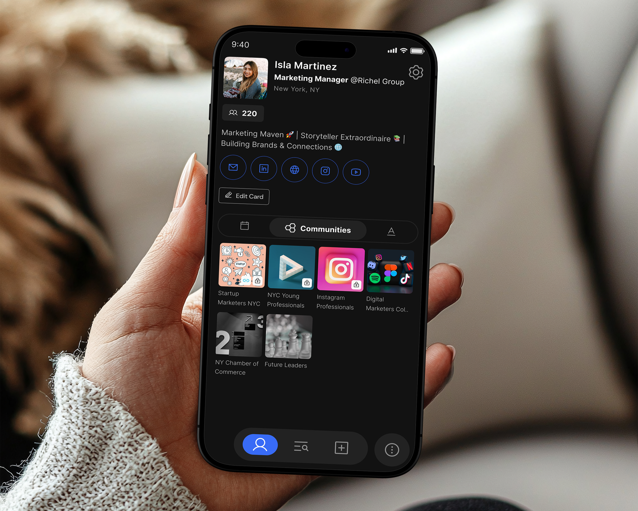 A person holding a smartphone displaying a LinkedIn profile page of Isla Martinez, Marketing Manager at Richel Group, based in New York, NY. The profile shows social media links and several community groups.