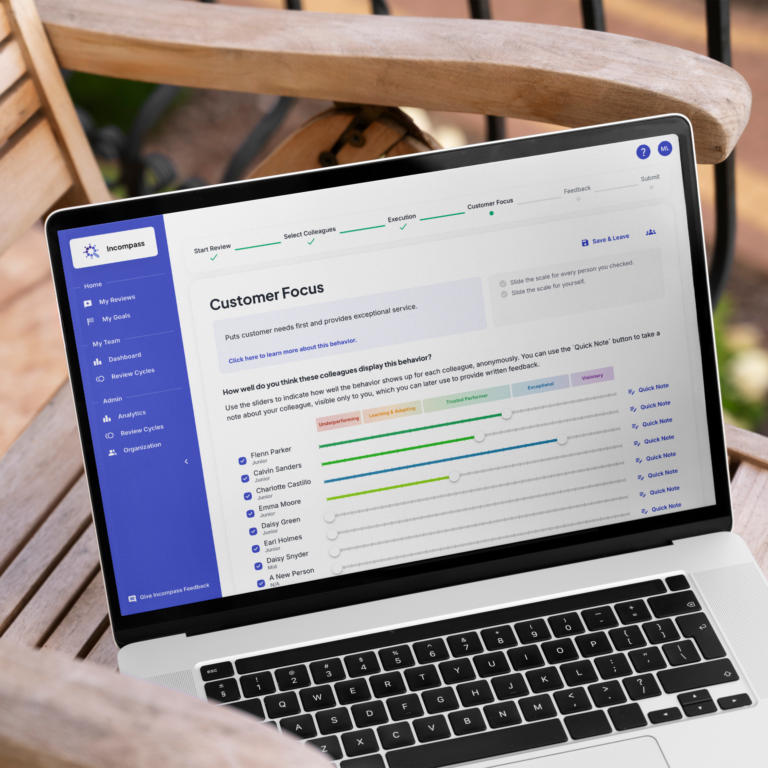Laptop screen displaying a customer feedback and review management dashboard on a wooden table outdoors.