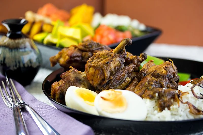 Chicken curry with rice, eggs, avocado, tomato and more