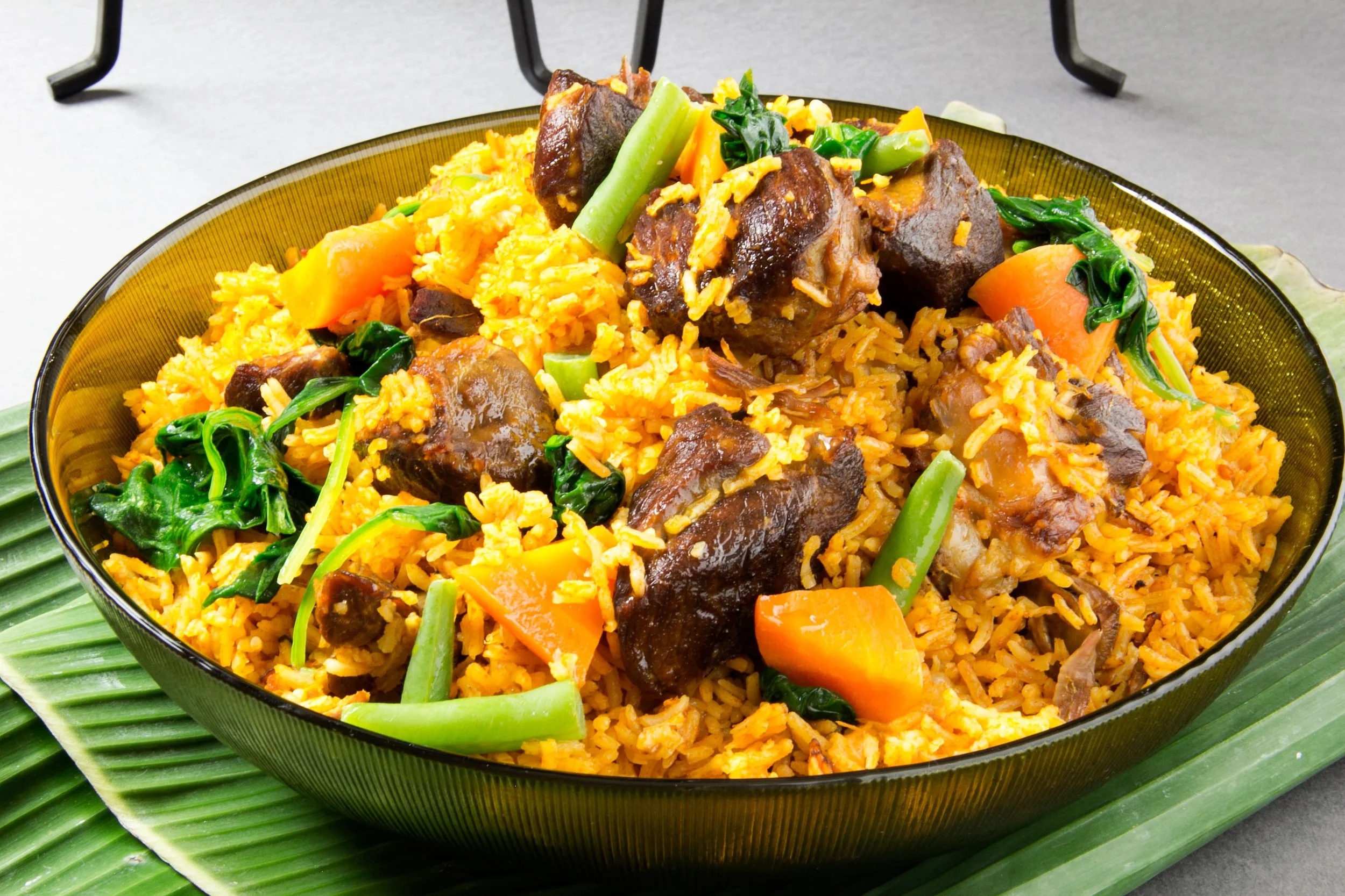 Lamb jollof rice, served with carrots, spinach and beans
