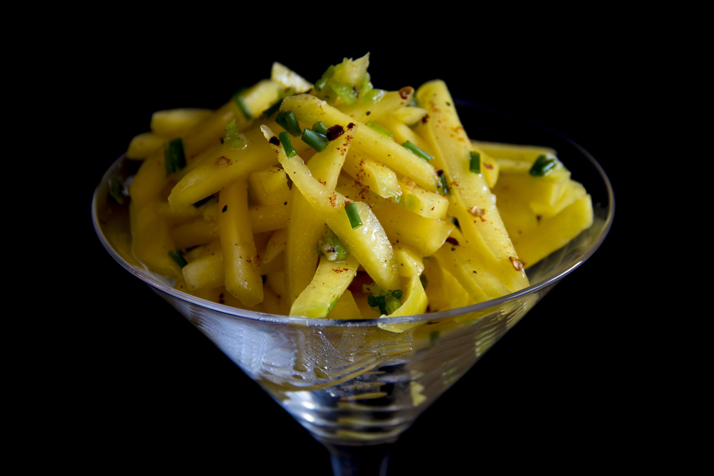 Green mango salad, presented in a cocktail glass