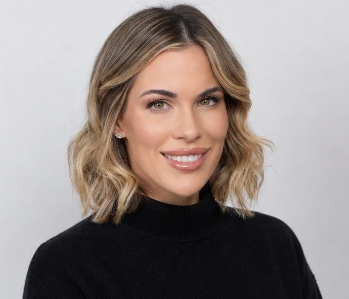 Sissi, founder of Behind Your Biz, smiling in a black top