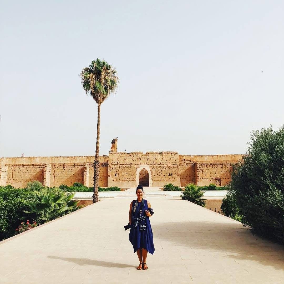 Woman in morocco holding many cameras