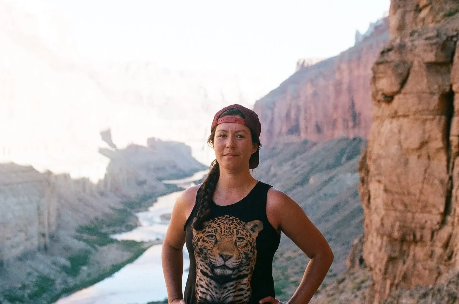 Woman standing in front of the Colorado River in the Grand Canyon