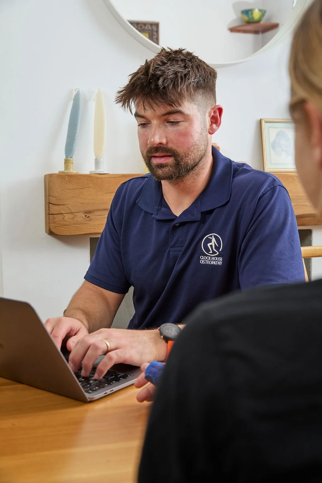 osteopath taking a case history during a home visit in beckenham