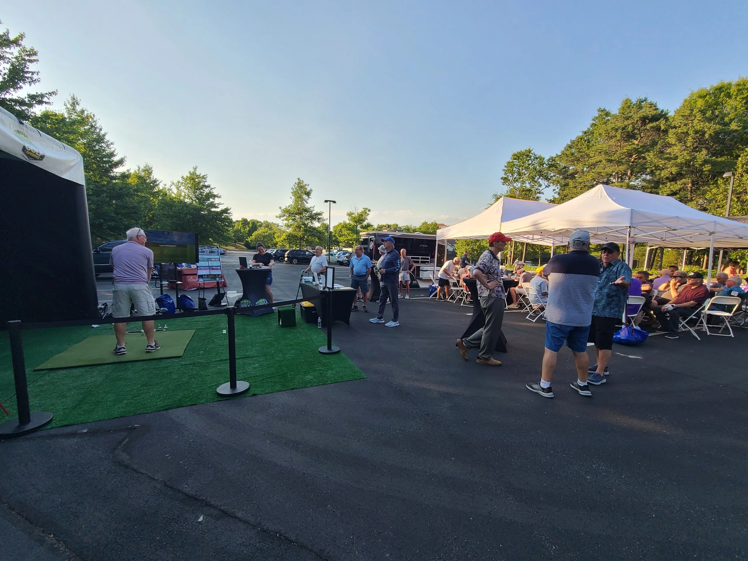 Mobile Event Solutions NJ and the MES Golf Experience Mobile Golf Simulator Set-up with tables, chairs, tents and games for 50 people