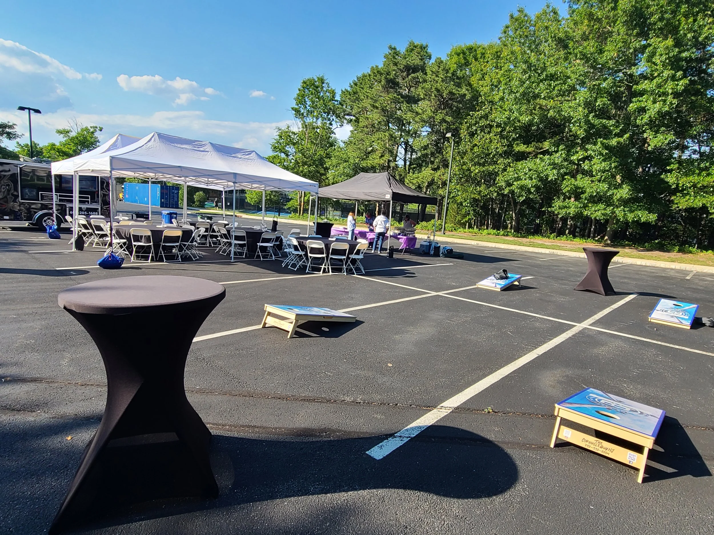 Mobile Event Solutions NJ and the MES Golf Experience Mobile Golf Simulator Set-up with tables, chairs, tents and games for 50 people
