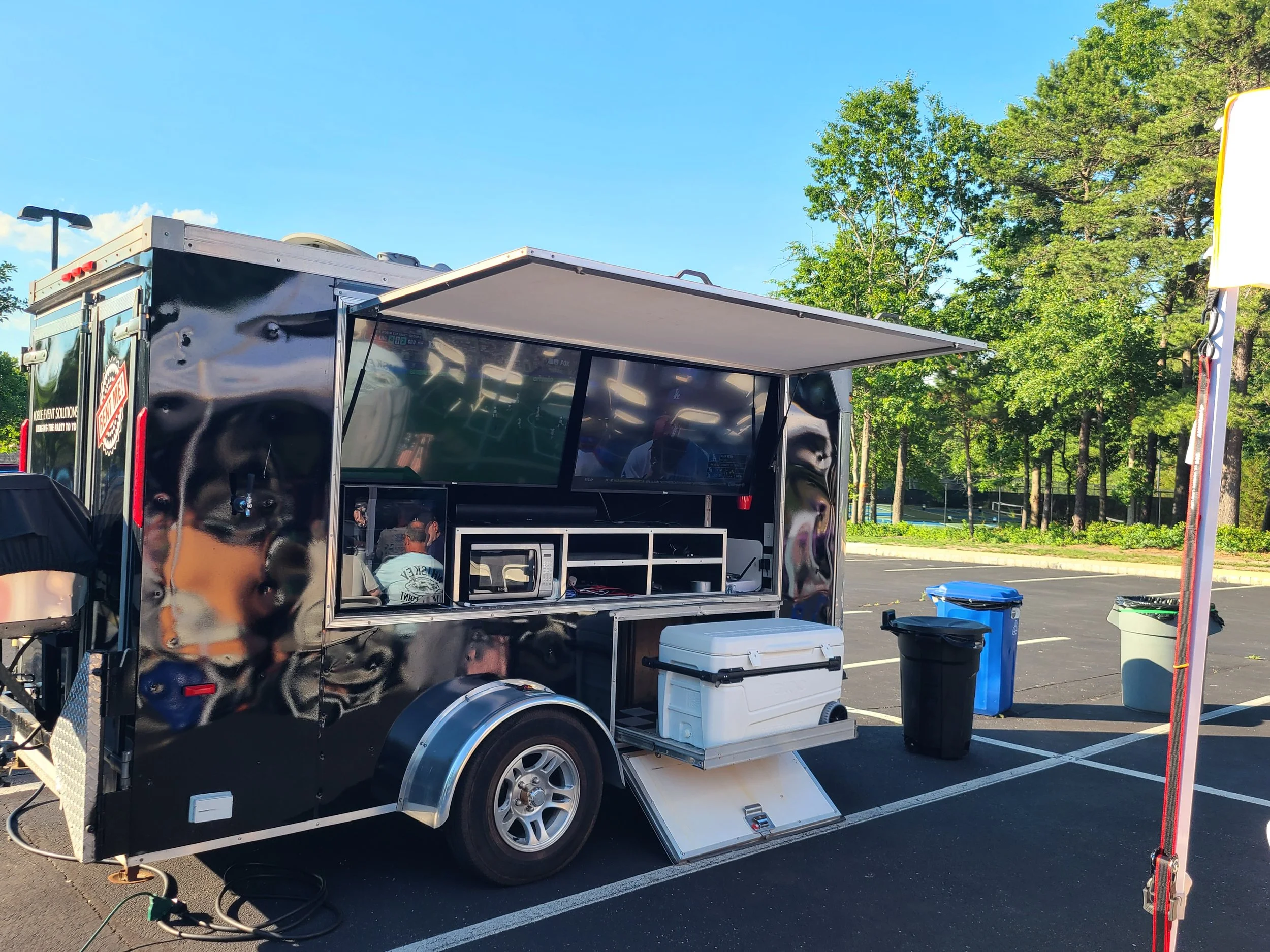 Mobile Event Solutions NJ and the MES Golf Experience Mobile Golf Simulator Set-up with tables, chairs, tents and games for 50 people