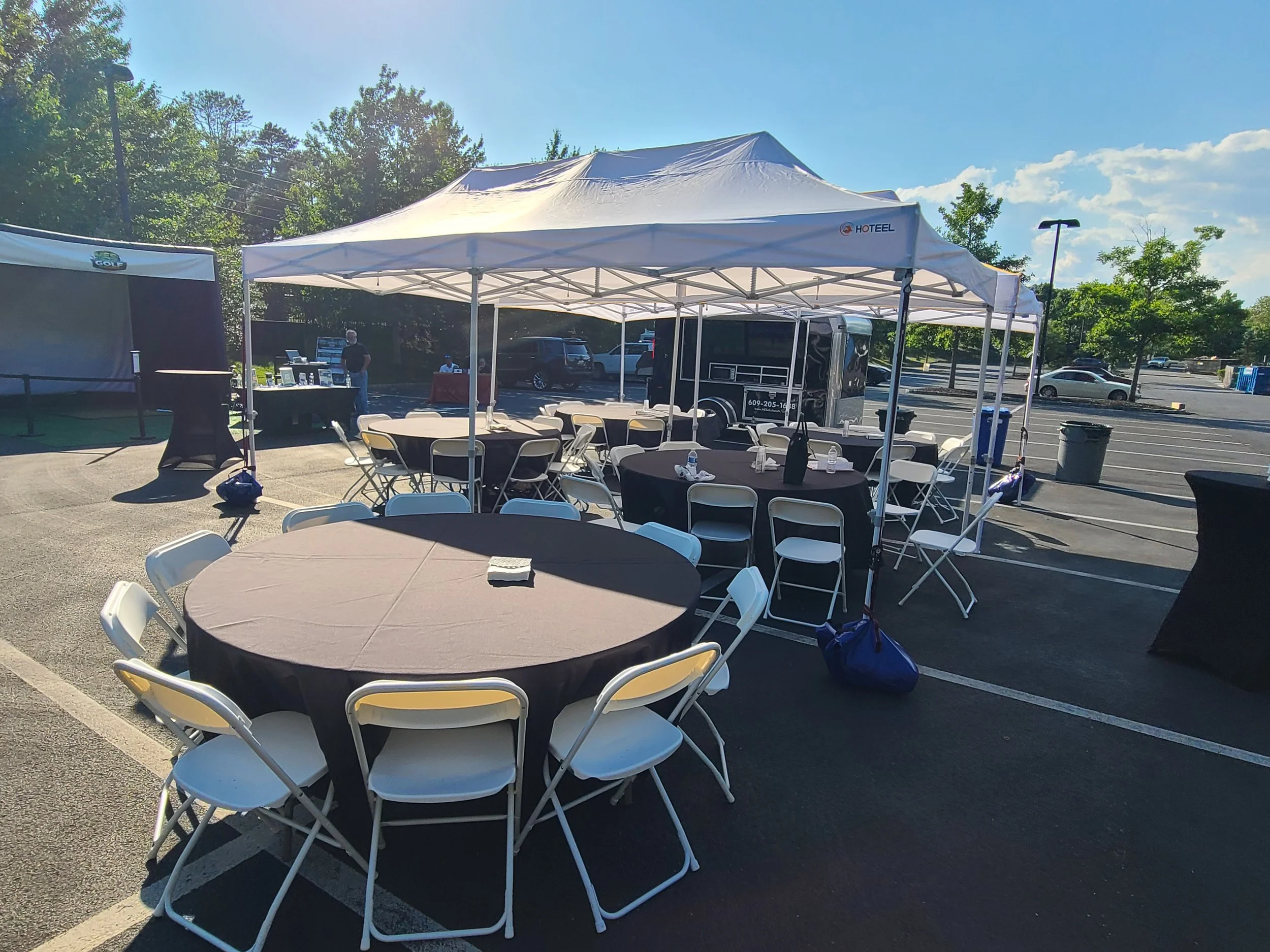 Mobile Event Solutions NJ and the MES Golf Experience Mobile Golf Simulator Set-up with tables, chairs, tents and games for 50 people
