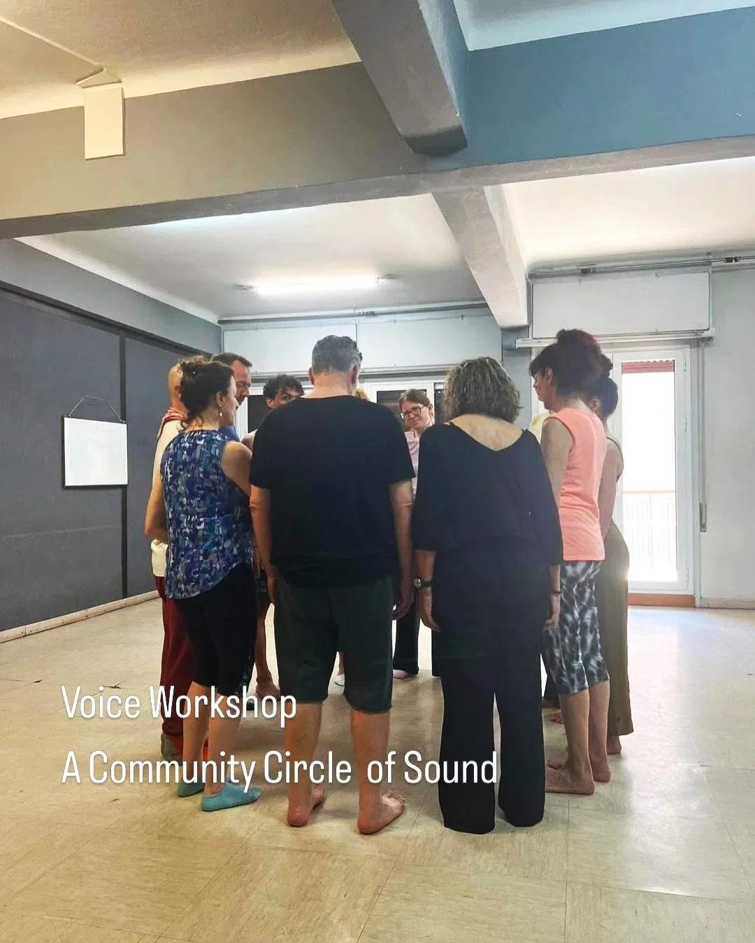 A group of people standing in a circle inside a room, engaging in a Voice Workshop titled 'A Community Circle of Sound'.