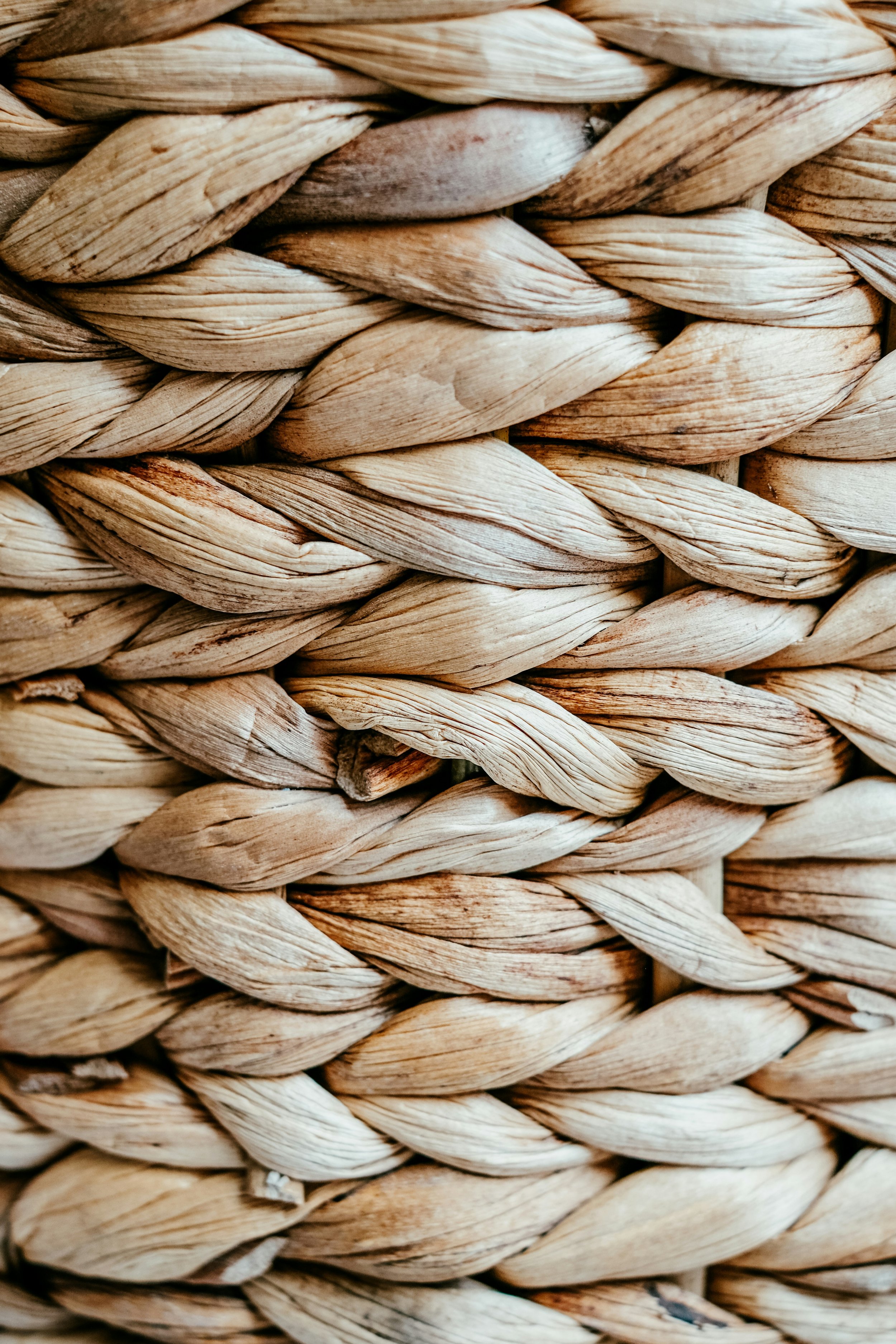 Close-up of tightly woven beige and light brown natural fibers.