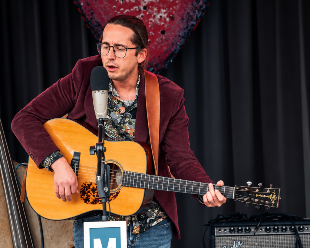 Bryan Dubrow playing acoustic guitar.