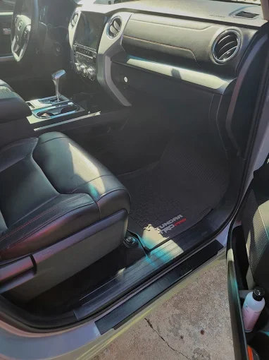 Interior of a car showing the front passenger seat, dashboard, and center console.