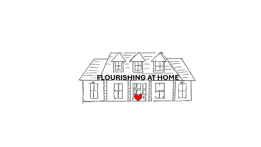 Sketch of a house with a sign that reads 'FLOURISHING AT HOME' and a red heart in front of the door.