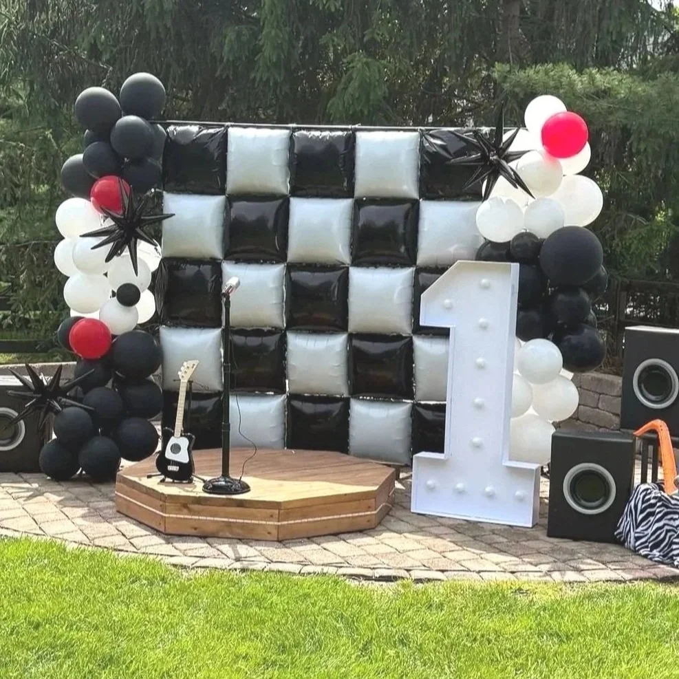 Black and white rock n roll party. With wooden stage for pictures.