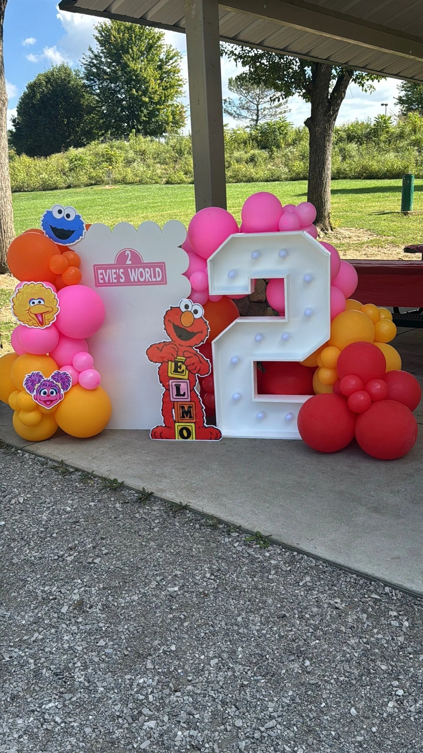 elmo backdrop with pastel balloons and vinyl wording 