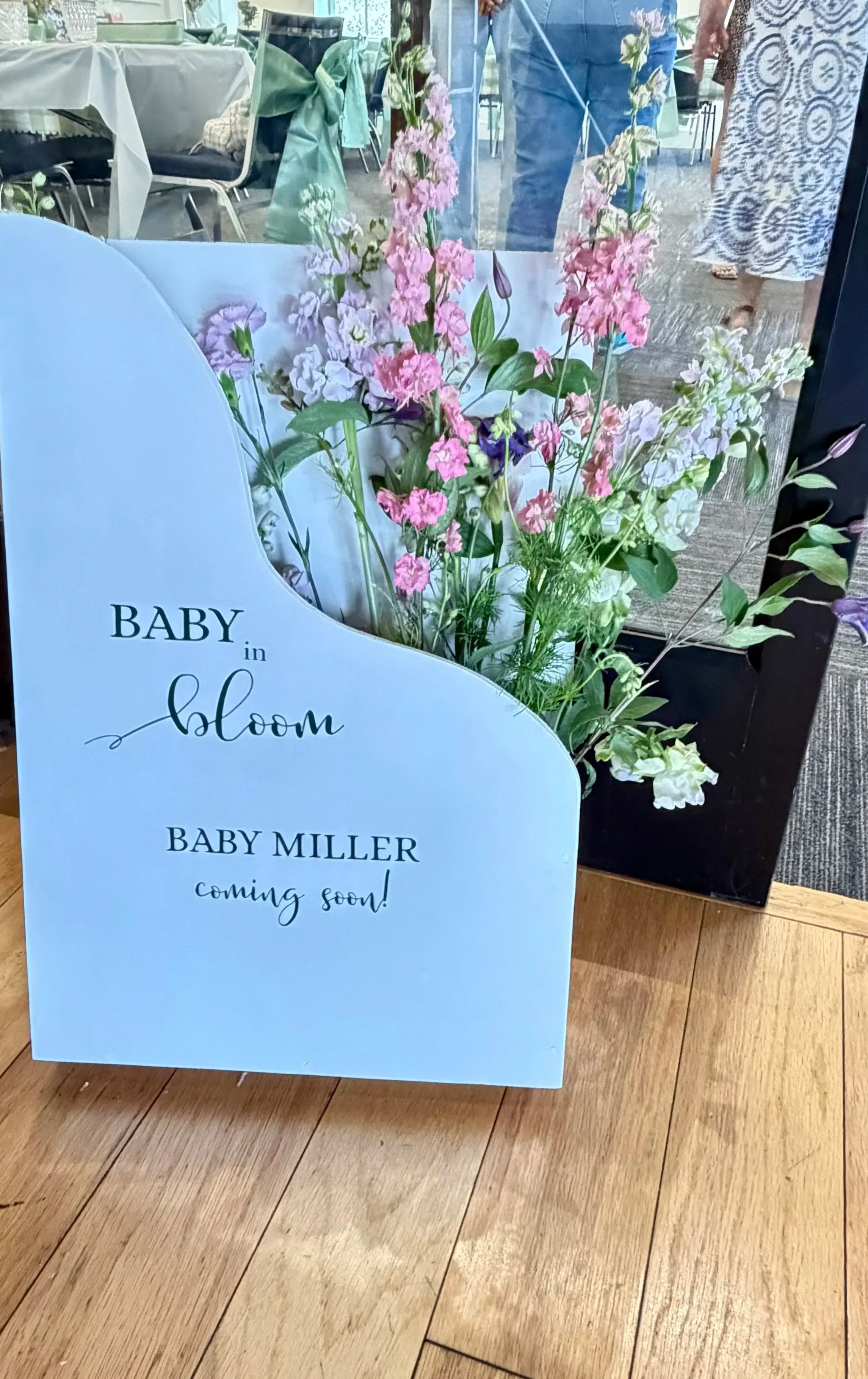 wooden welcome sign with flowers and customized with vinyl lettering