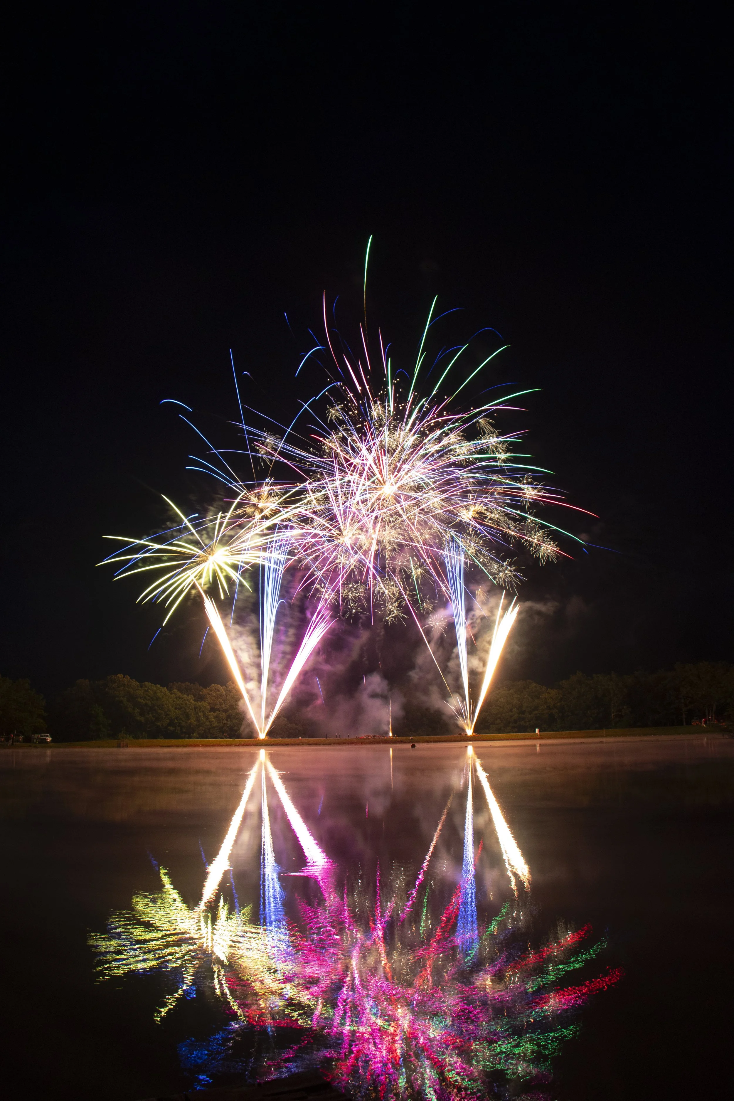 Pastel Fireworks over lake, professional fireworks