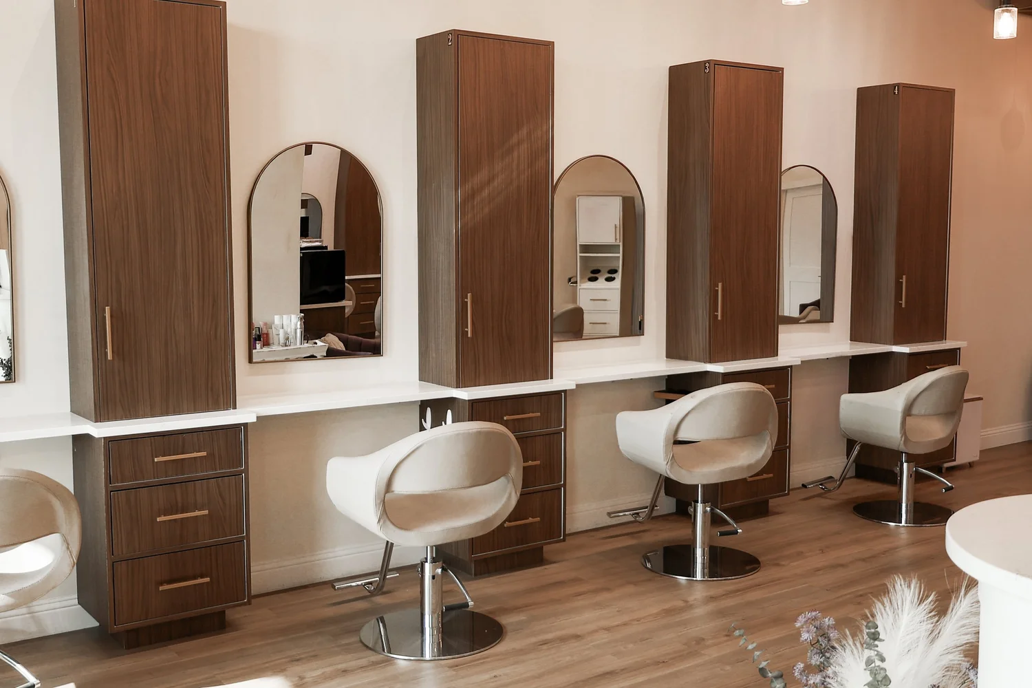 Styling stations and warm wood interiors at The Purple Chair Salon & Spa