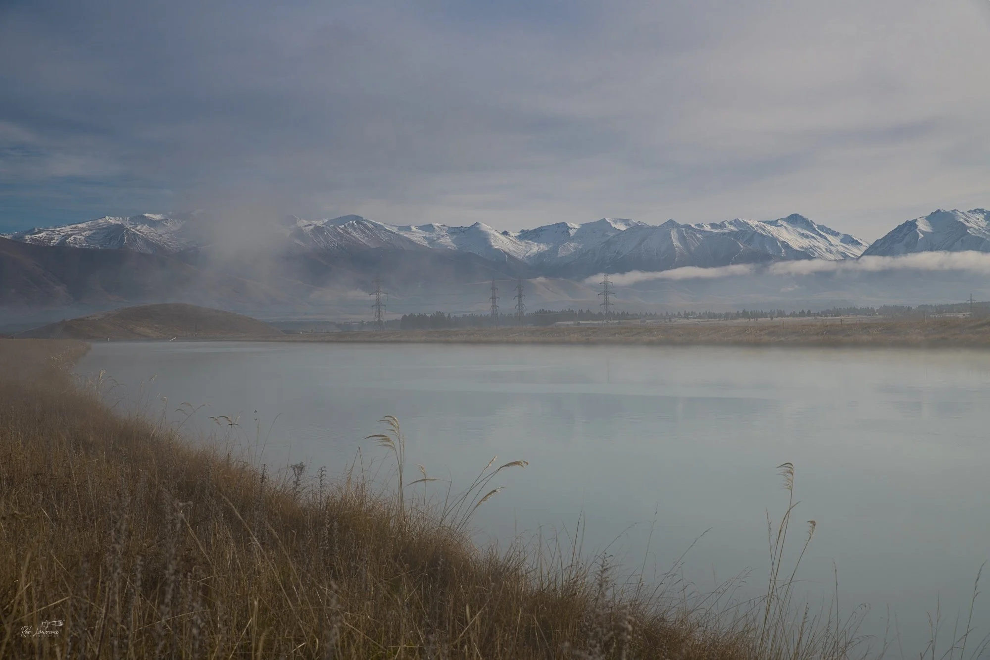 Morning Silence
The early morning mist drifts across the Benmore Canal, with the Benmore Range rising quietly in the background. There is a peaceful serenity as the mist glides over the glacial waters, while the first light of day reaches the Mackenz