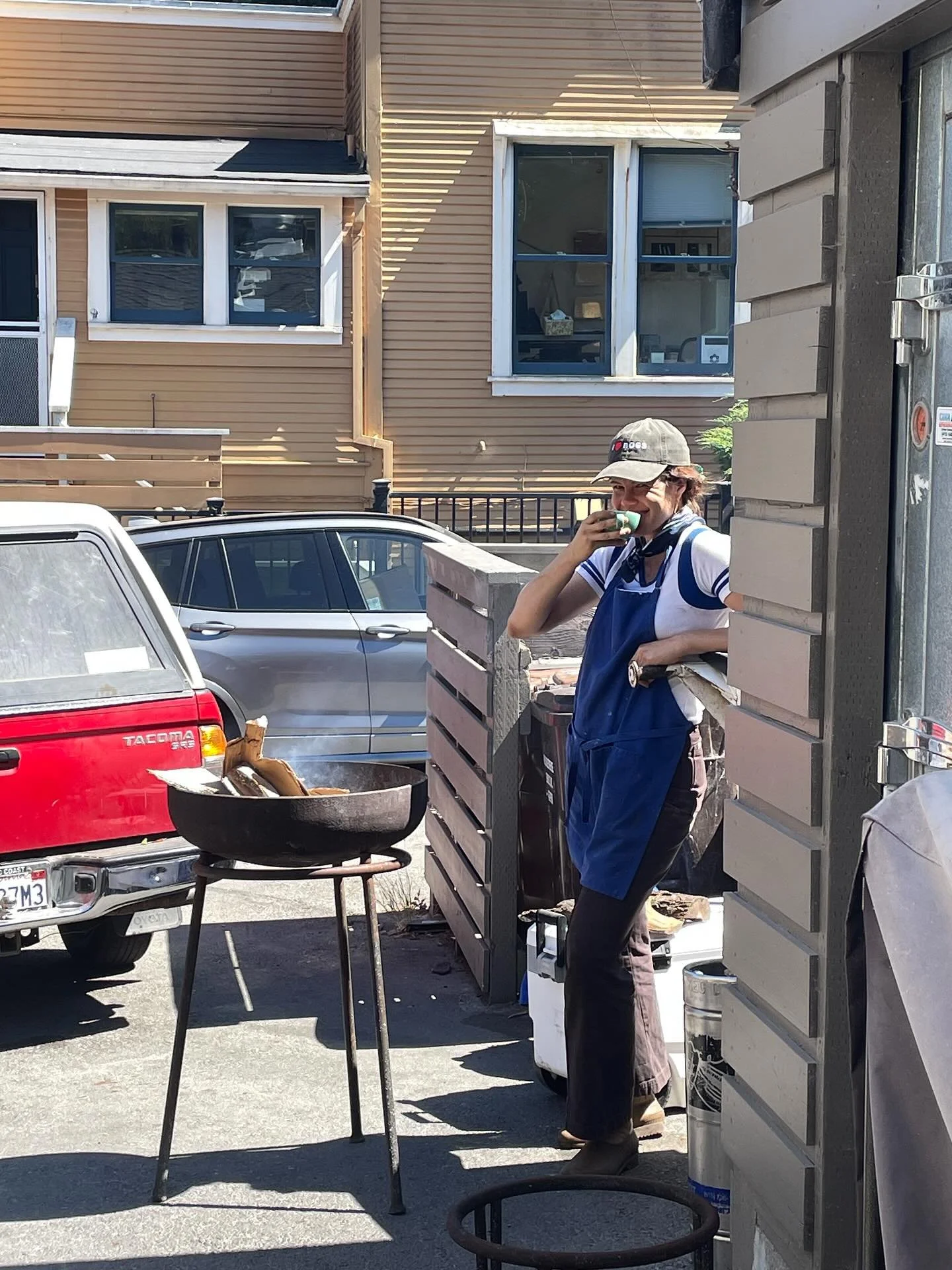 my happy place captured by @jessicadeanharrison - building a fire in my @jorgenharleblacksmith plancha, drinking espresso, getting psyched. What a life, that I get to support small farmers, laugh with friends and bring people together around beautifu