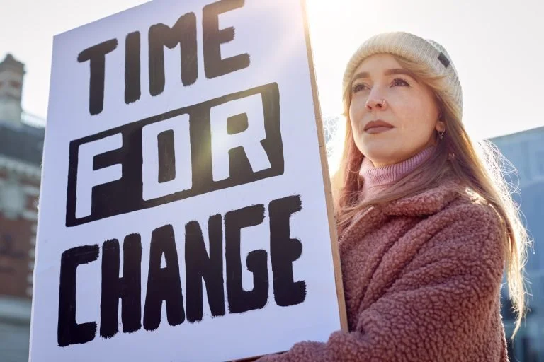 female-protestor-on-demonstration-march-holding-ti-2024-10-19-10-30-39-utc-768x512.jpg