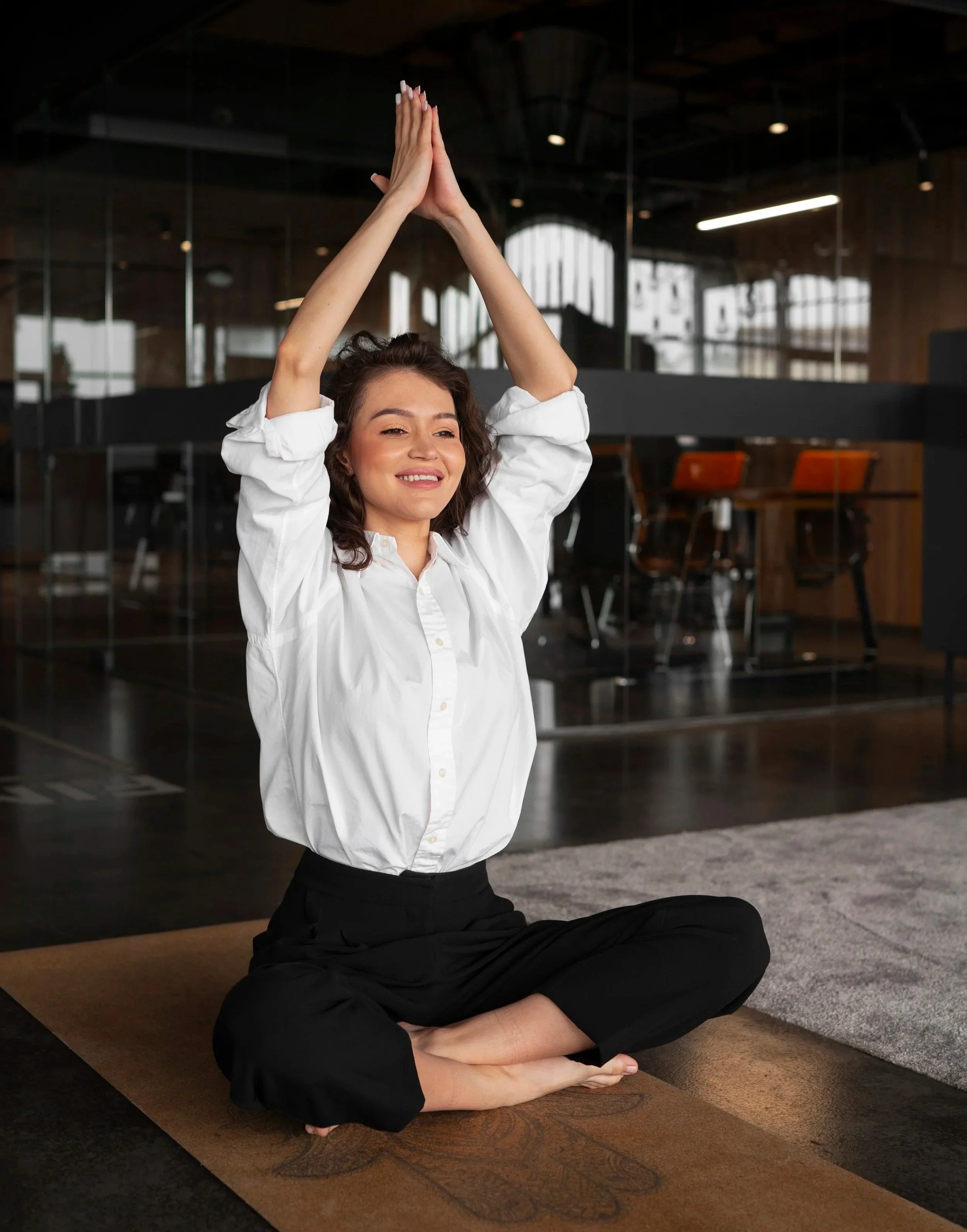 Woman executive doing mindfulness practice at work, leadership development, corporate wellness, workplace wellness