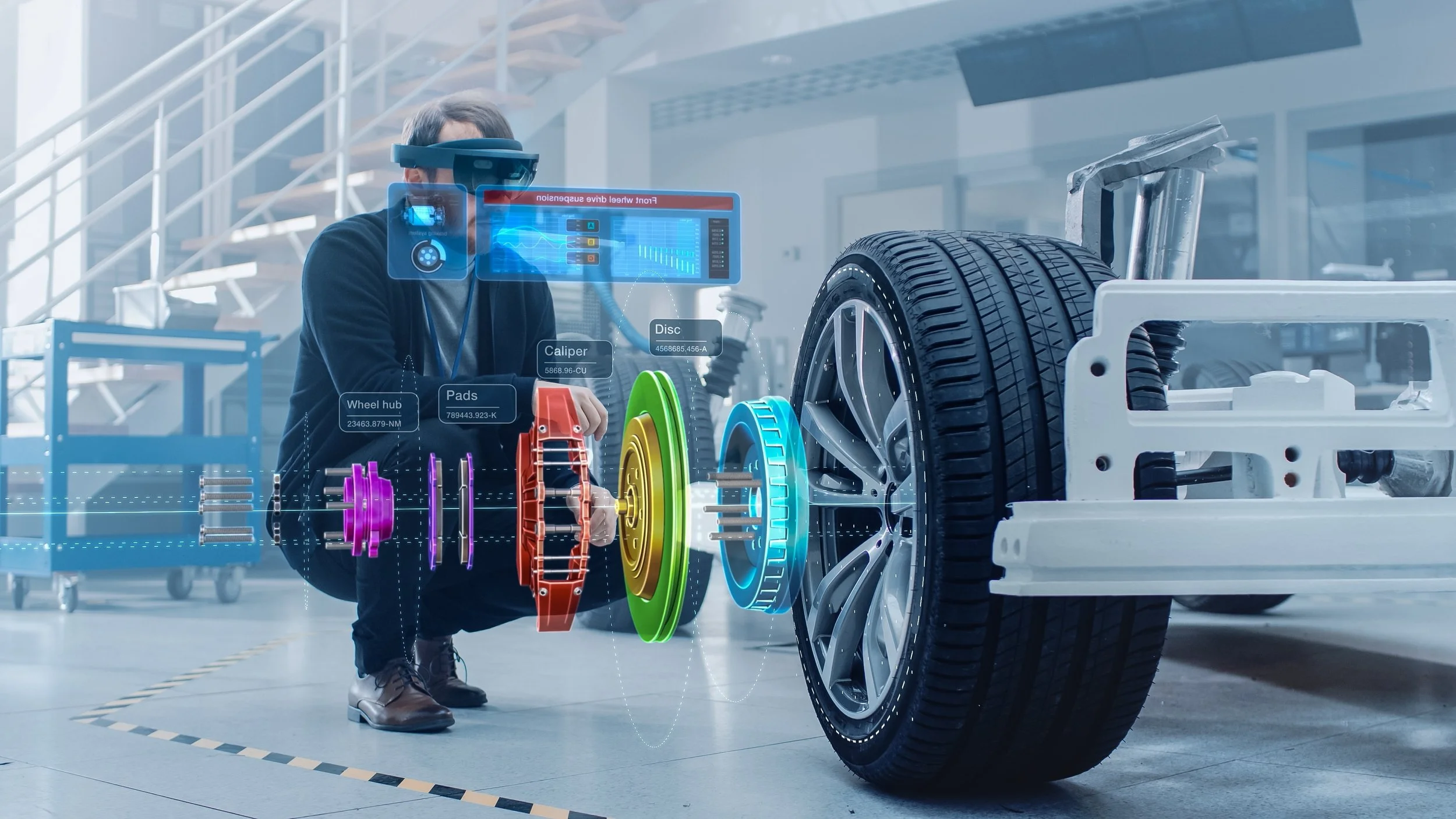 Technician wearing a virtual reality headset inspects a car's wheel assembly with digital overlays of automotive parts and information in a modern workshop.