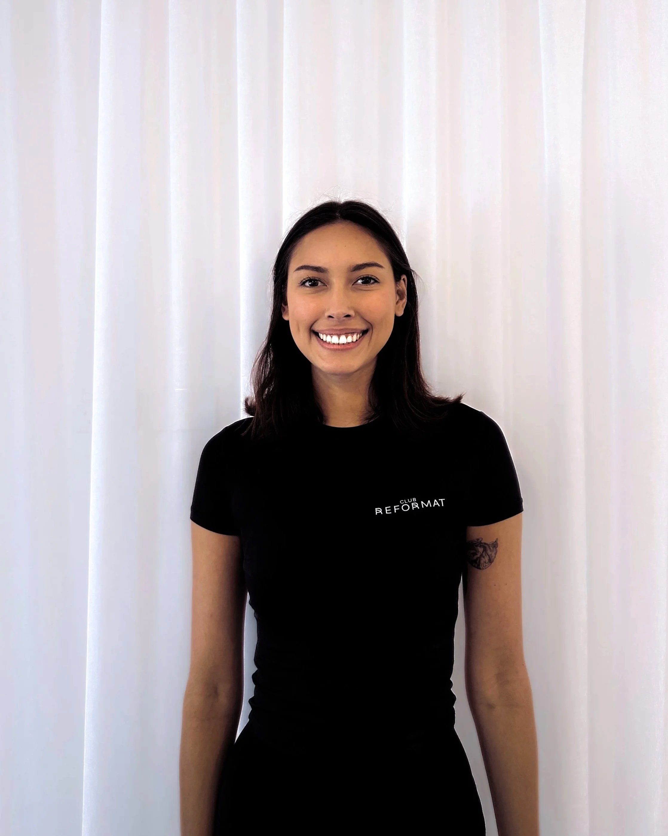 pilates instructor woman with dark hair and big smile