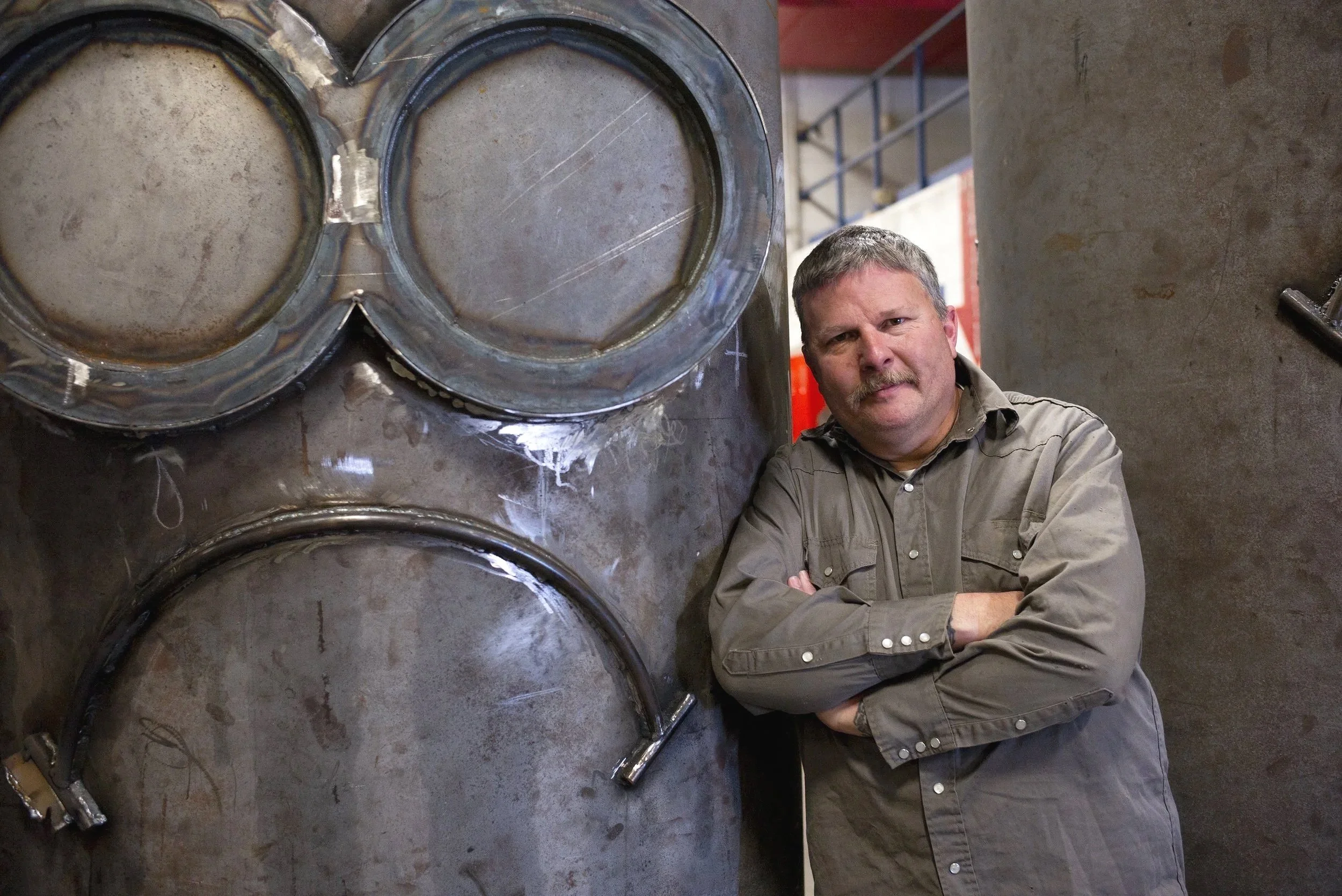 Jeremy Lovell, Metal Arts teacher at Simpson HS in Franklin, KY stands by his steel sculpture of a Minion.
