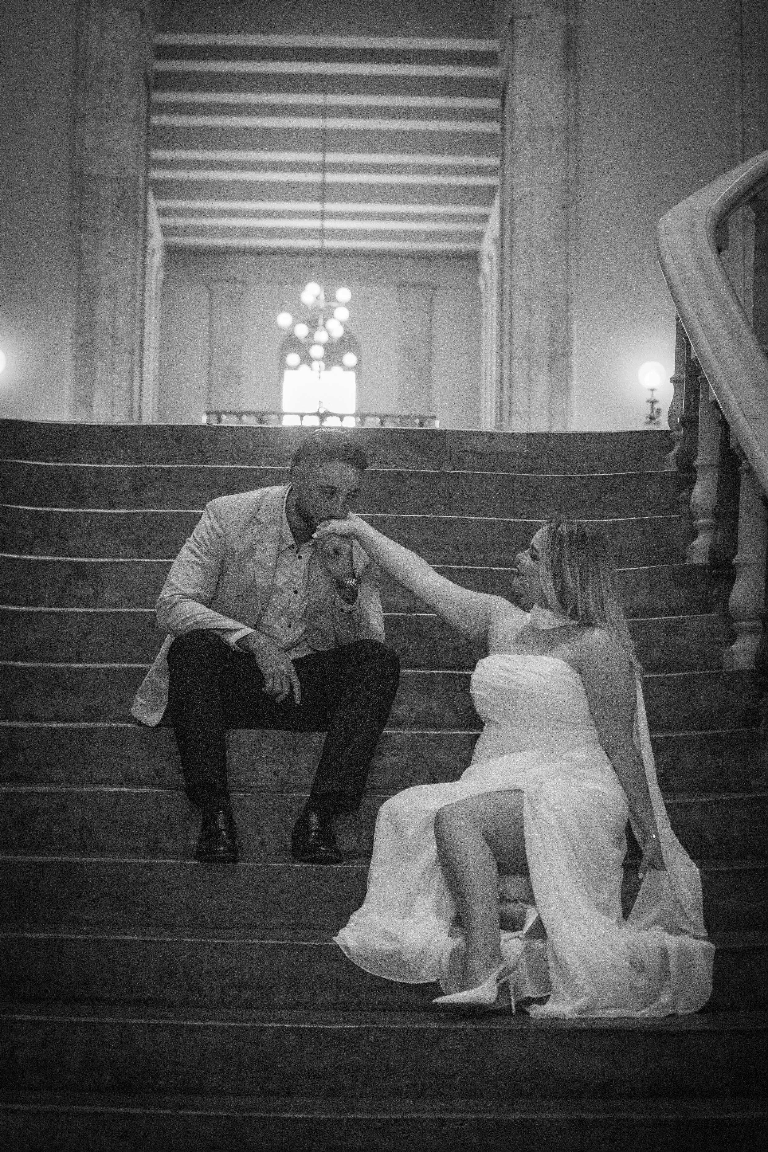 man kissing woman's hand