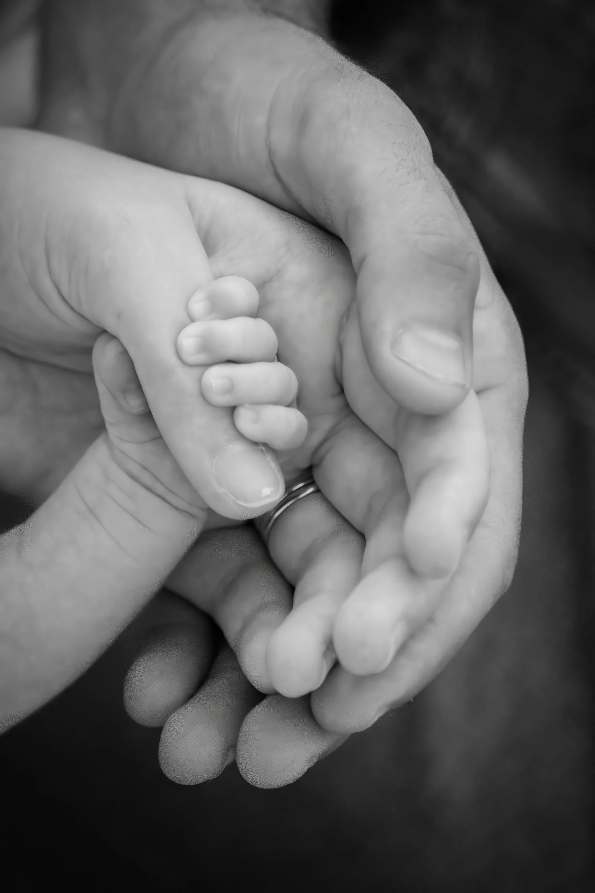 baby holding moms hand