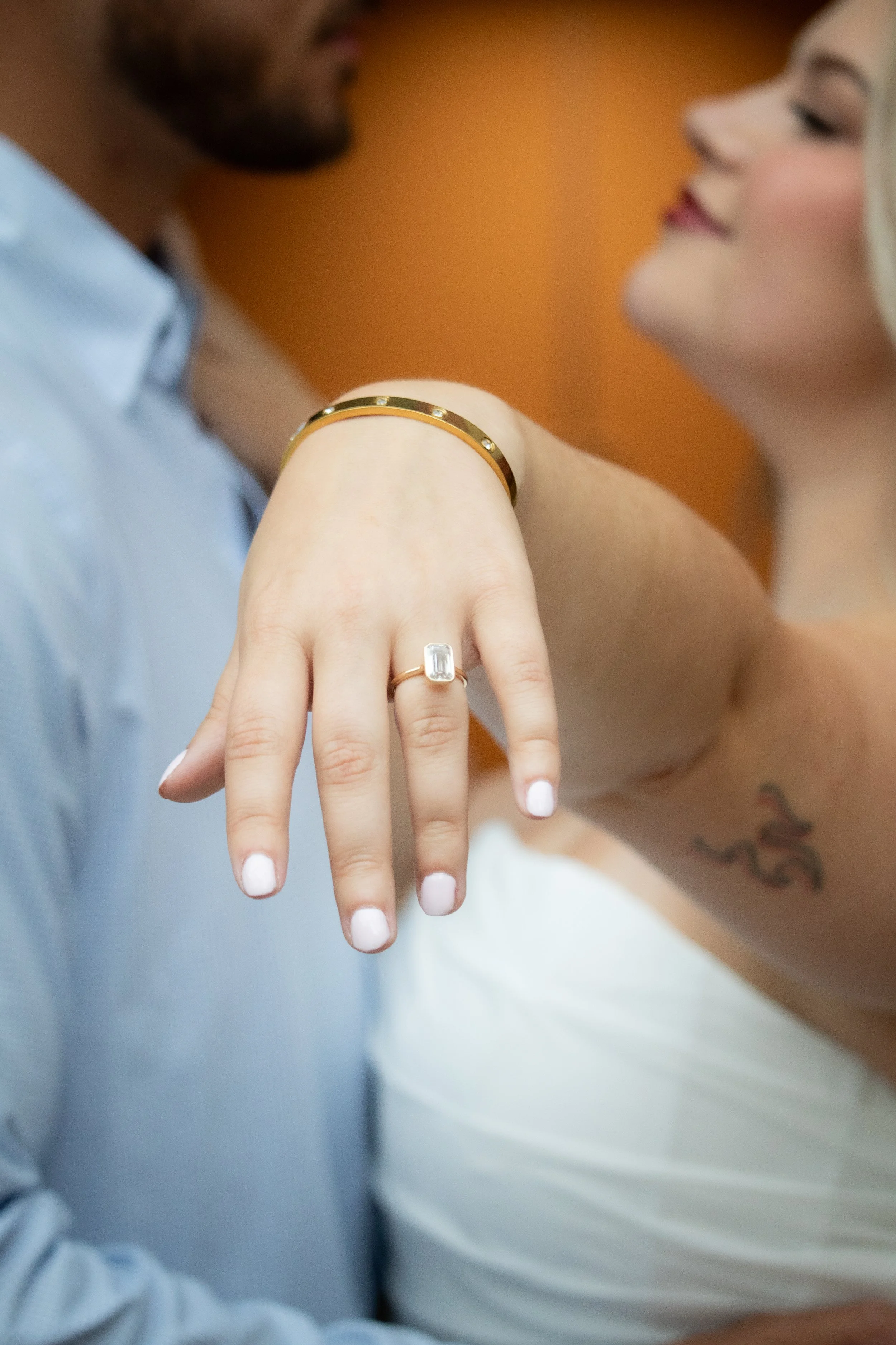 ring and couple in back ground