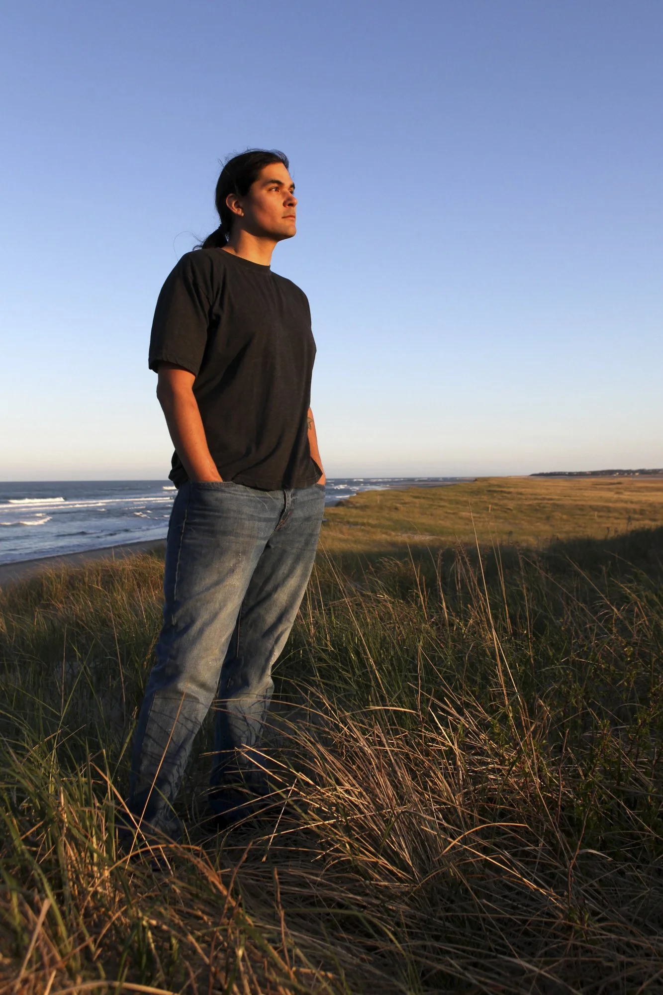Billy Best stands at Coast Guard Beach in Eastham, Massachusetts, in a portrait created years ago for the cover of his book The Billy Best Story. Diagnosed with Hodgkin lymphoma at sixteen, Best became known nationwide after running away from chemoth