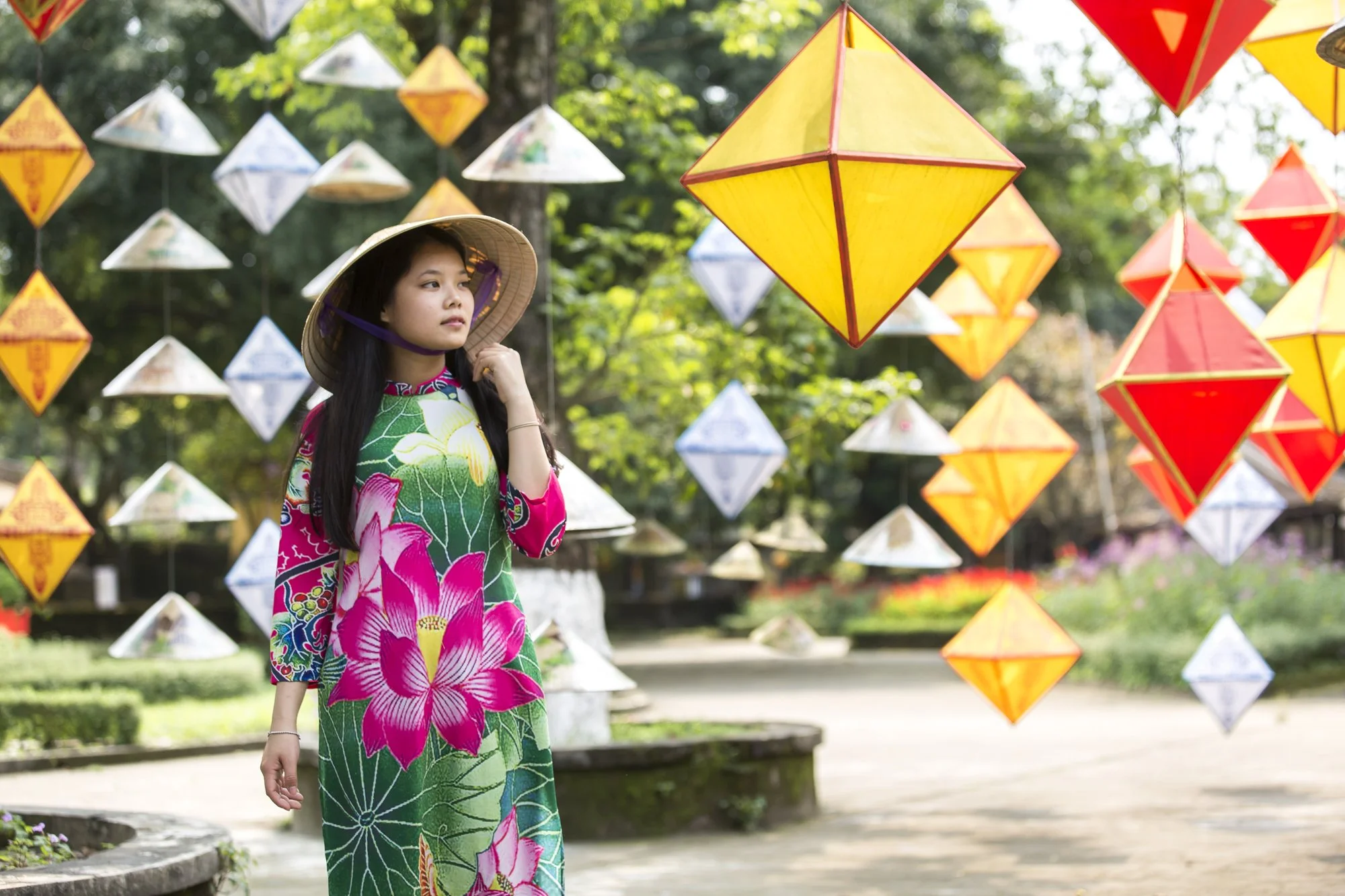 Thanh Nhàn sells paper lanterns at the Citadel in Huế, Vietnam, but her passion is crafting handmade paper flowers, each accompanied by an original poem. She hopes to open her own shop one day to share her art more widely.