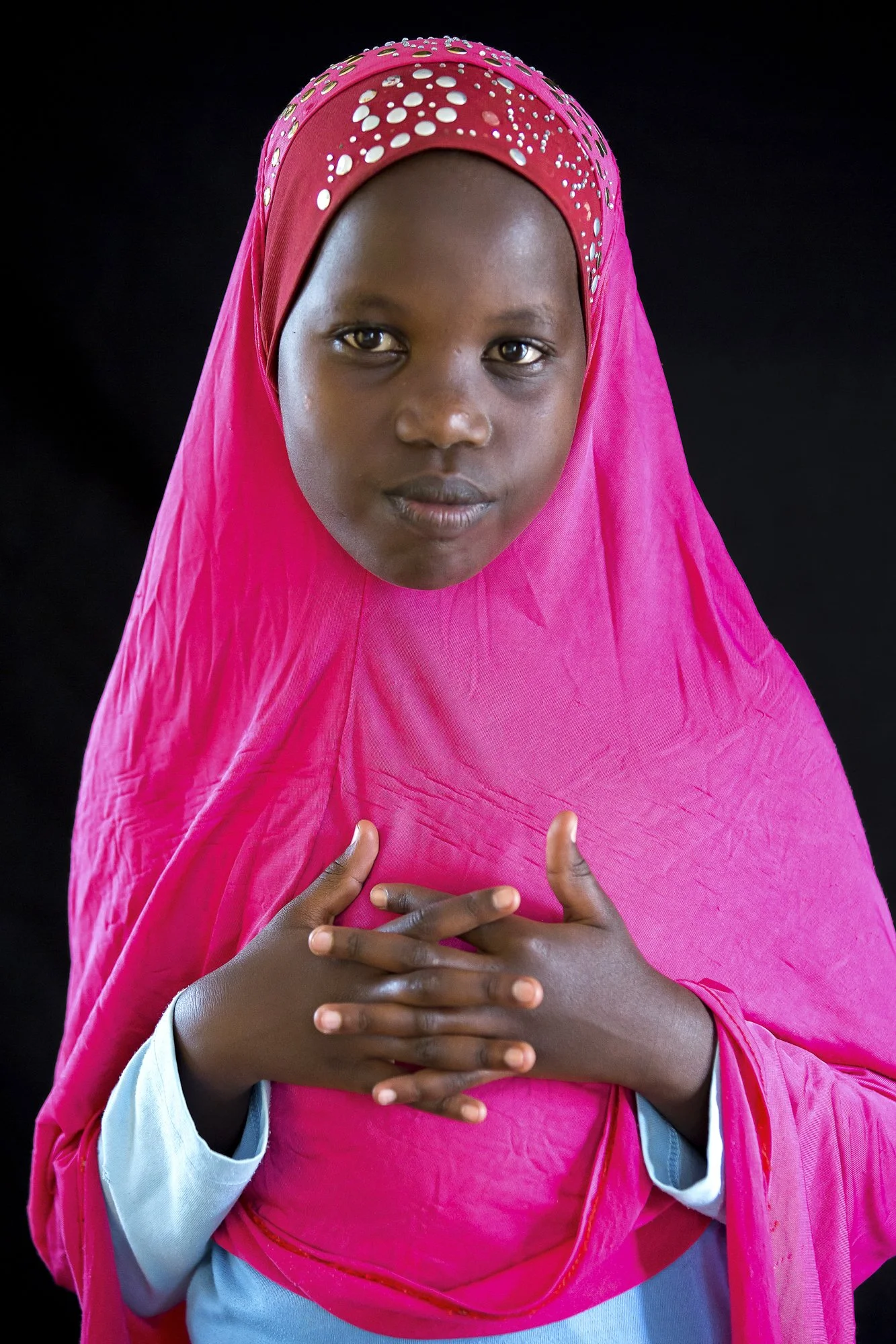 Umetesi watches quietly from the edge of the classroom at the “Through the Eyes of Hope” program in Kigali, Rwanda, even though the lessons are mostly attended by older boys. Rwanda has one of the highest literacy rates for girls in Africa, yet girls